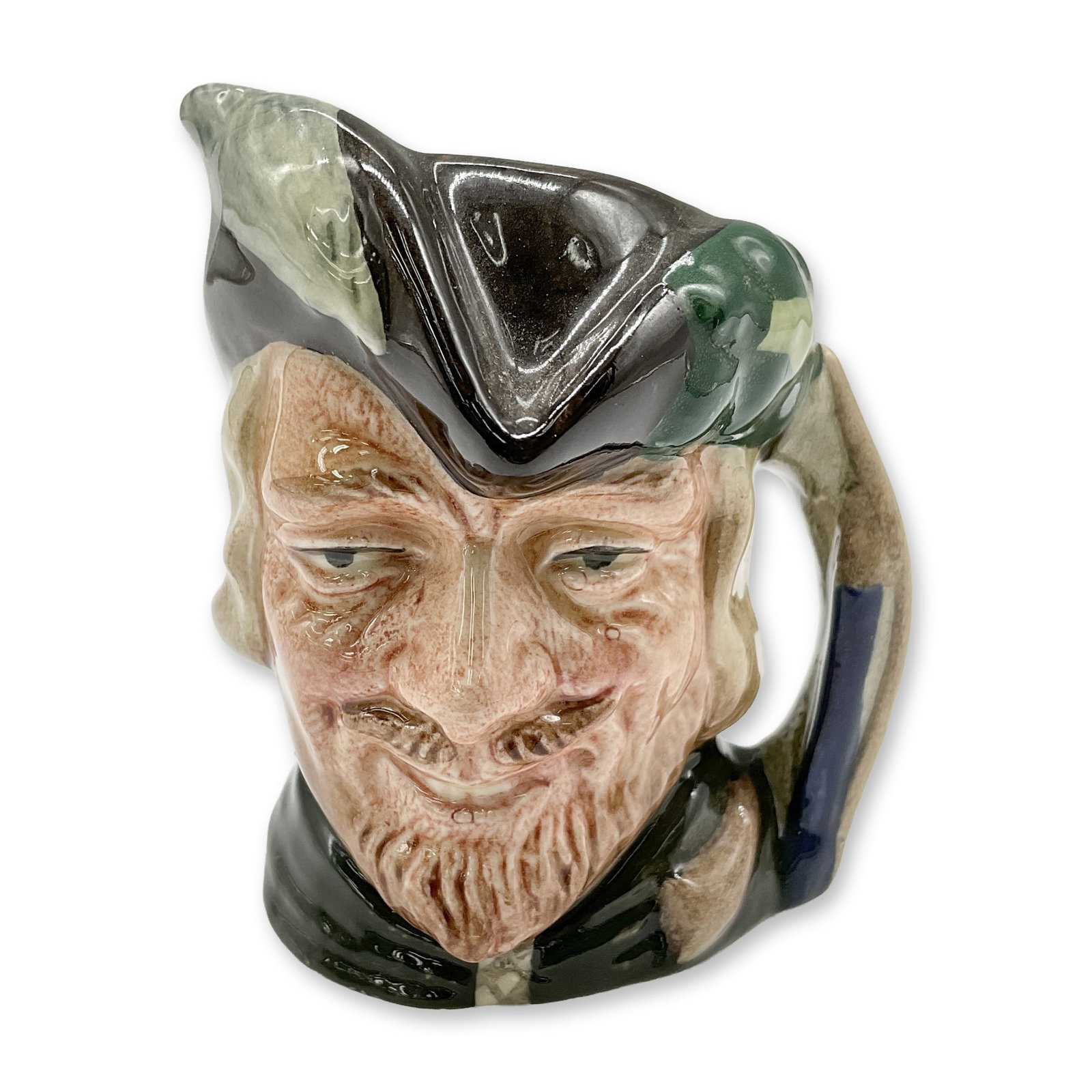 Robin Hood D6541 - Mini - Royal Doulton Character Jug: Style Two. Brown hat with white feather on one side and oak leaves and acorns on the other; green robes. Royal Doulton backstamp. Artist: Max Henk Dimensions: 2.75"H Date or Era: 1960 - 1991 Manufactu