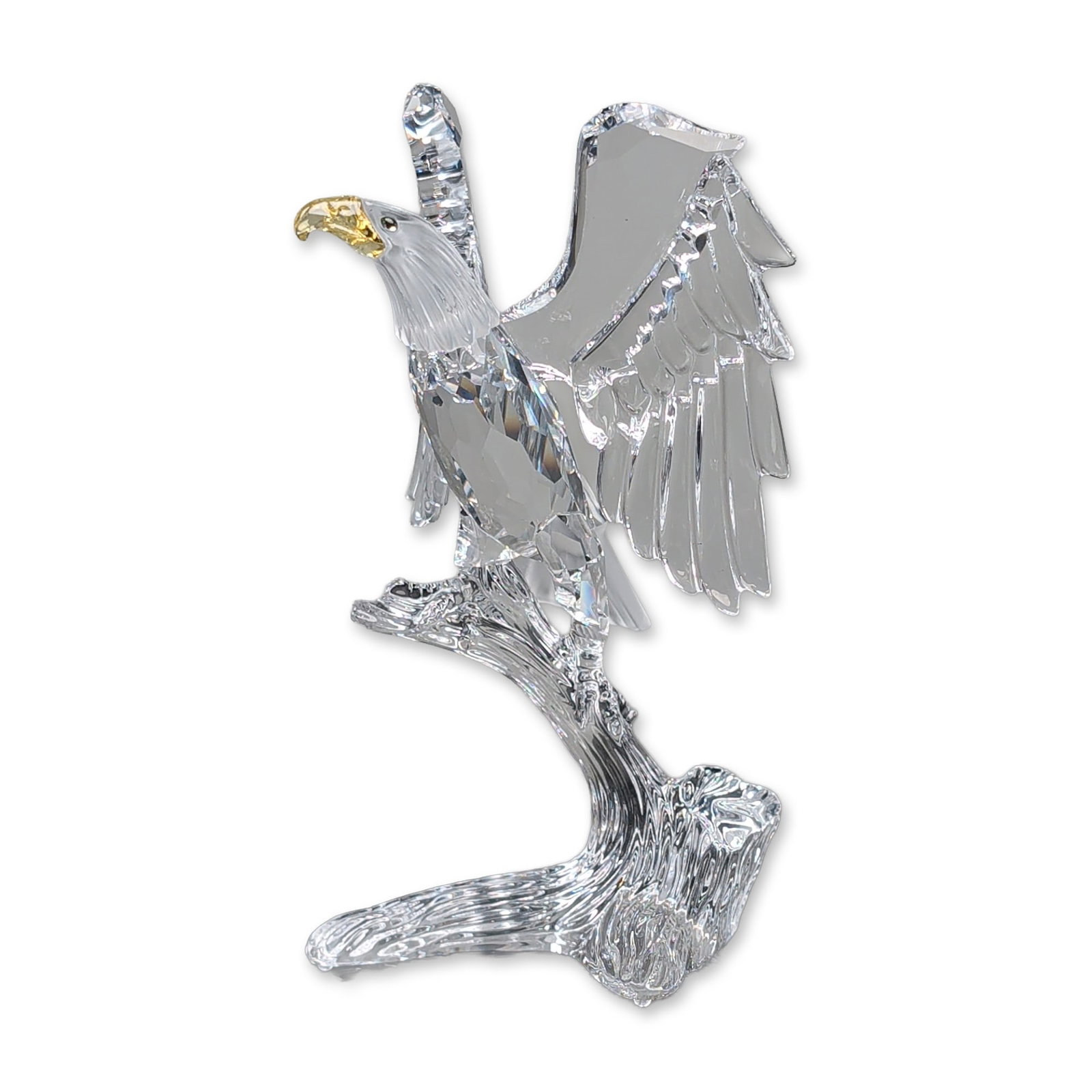 Swarovski Silver Crystal Figurine, Bald Eagle: Figurine from the Feathered Friends series is in faceted and frosted lead crystal depicting a bald eagle landing on a branch. The eagle features a faceted body and wings, frosted head and tail feather
