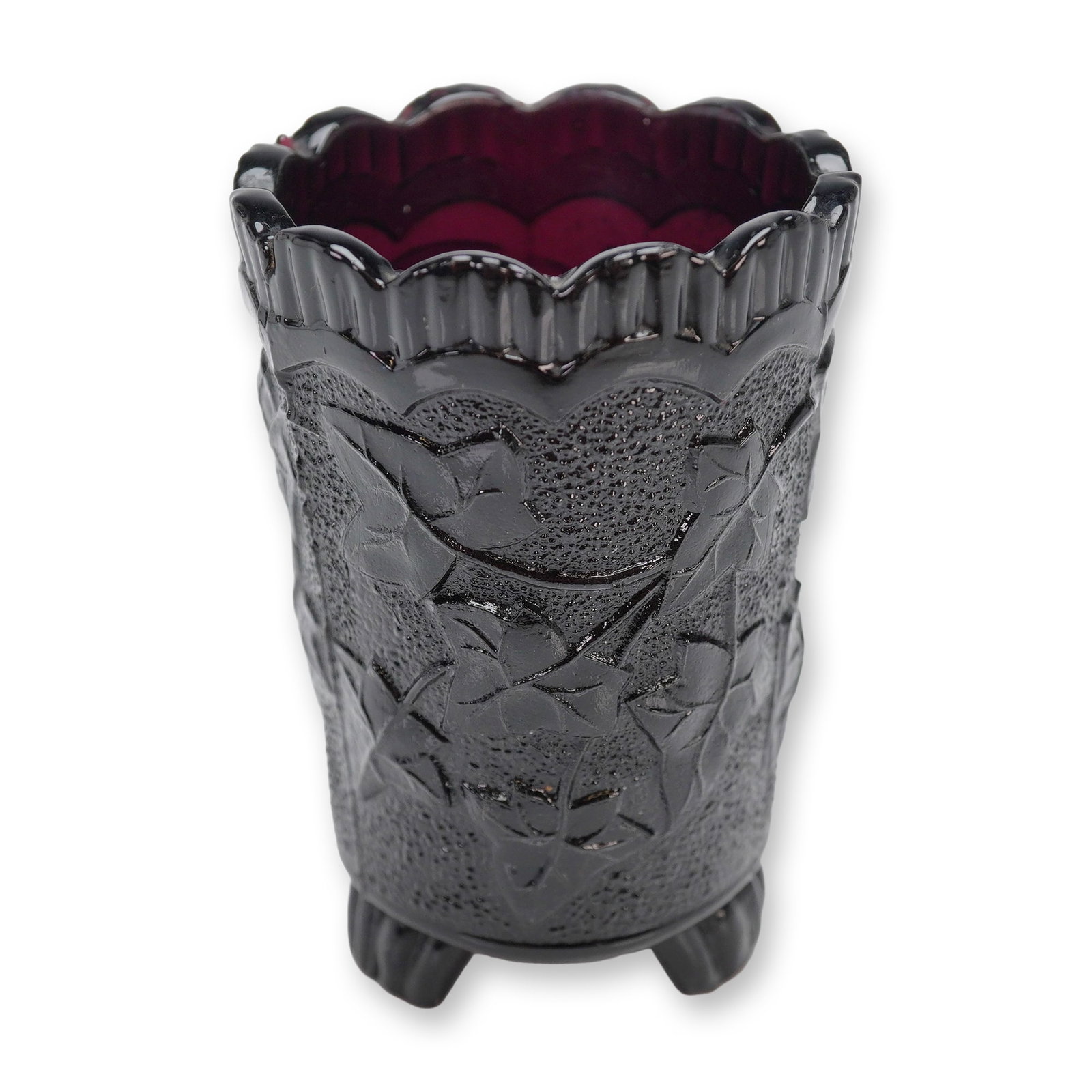 Victorian Pressed Glass Mini Footed Vase Amethyst Ivy Pattern: A single miniature pressed glass vase, likely dating to the Victorian era (c. 1880s), consistent with Early American Pressed Glass (EAPG) or English pressed glass manufacture. The vessel is cylindrica