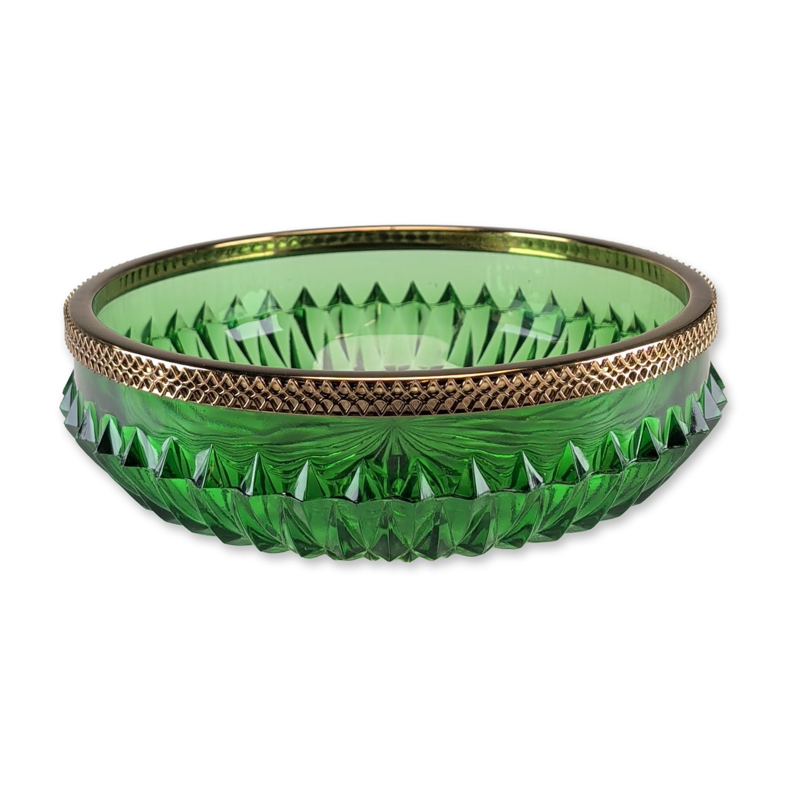 Emerald Green Cut Glass Metal Mounted Bowl: An emerald-green glass bowl featuring deep vertical wedge-cut facets and a large radiating starburst pattern to the base. The piece is finished with a gold-tone metal-mounted rim decorated in a repeat