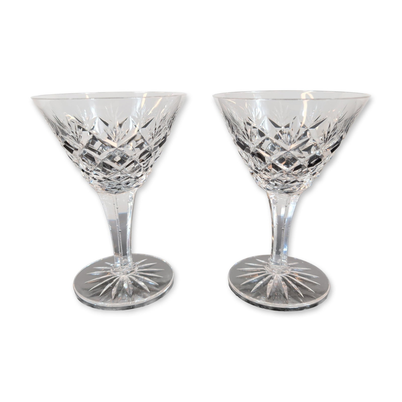 Pair of Cut Crystal Stemmed Wine Glasses: Pair of cut lead crystal stemmed glasses featuring a V-shaped bowl decorated with a cut criss-cross diamond pattern on the lower portion and vertical wedge cuts extending toward the plain rim. The mul