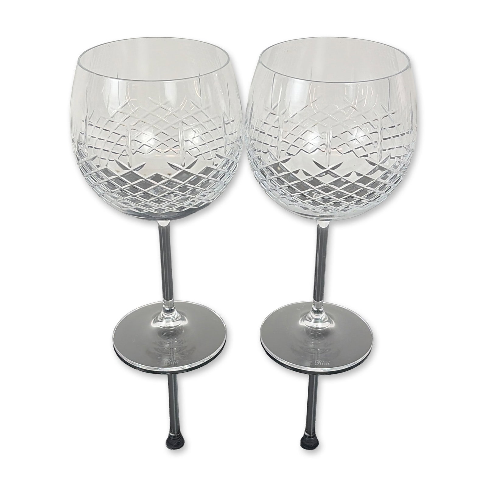 Pair of Ricci Cut Crystal Balloon Wine Glasses: Set of two Ricci Argentieri cut crystal wine glasses. Each glass features a globular bowl decorated with a precision diamond cut pattern to the lower half, transitioning to a clear upper section. The 