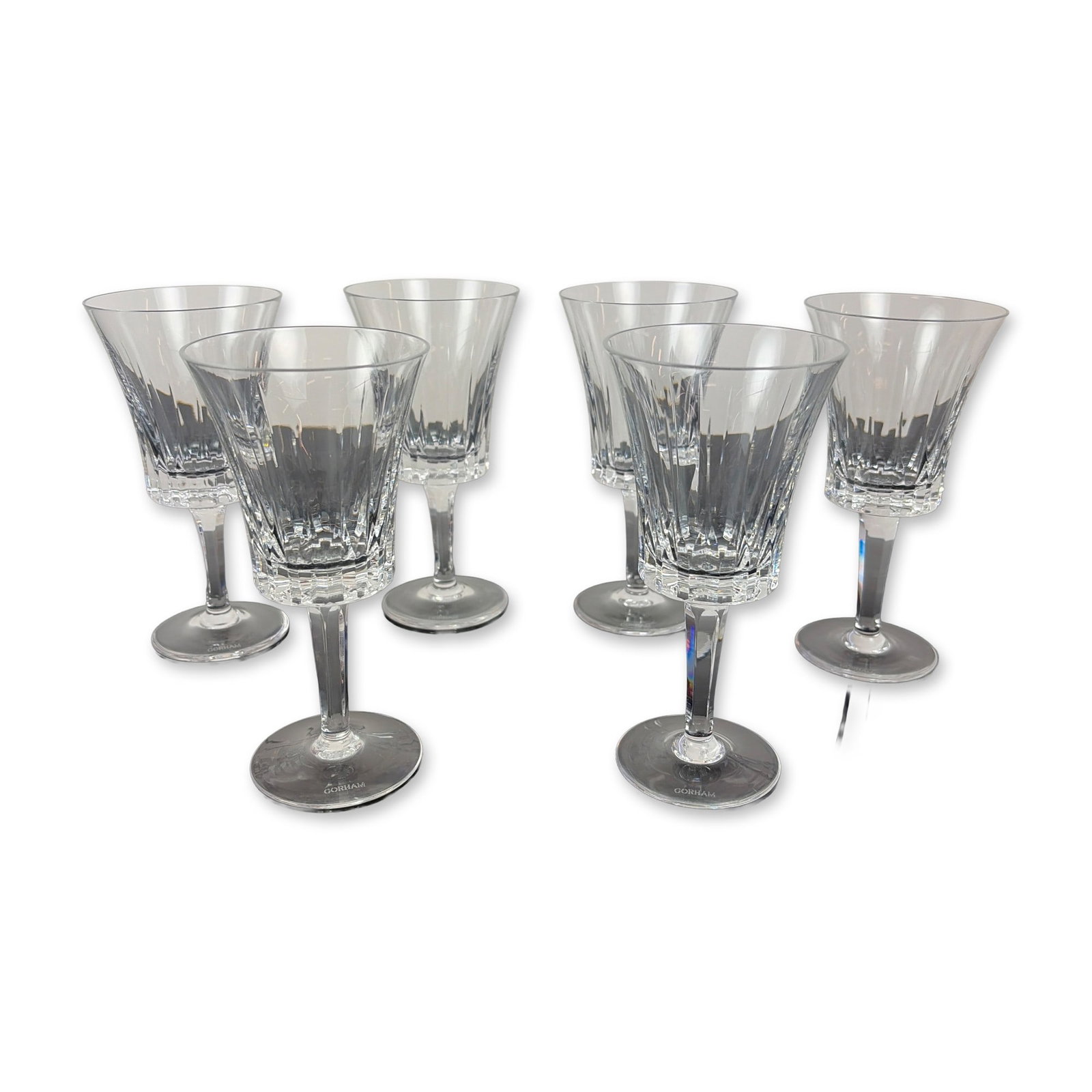 Set of Six Gorham Richelieu-Rondo Crystal Wine Glasses: Each glass features vertical wedge cuts on the upper portion of the bowl transitioning into a deeply faceted, paneled base. The faceted, multisided stems lead to a plain circular foot. Each piece is m