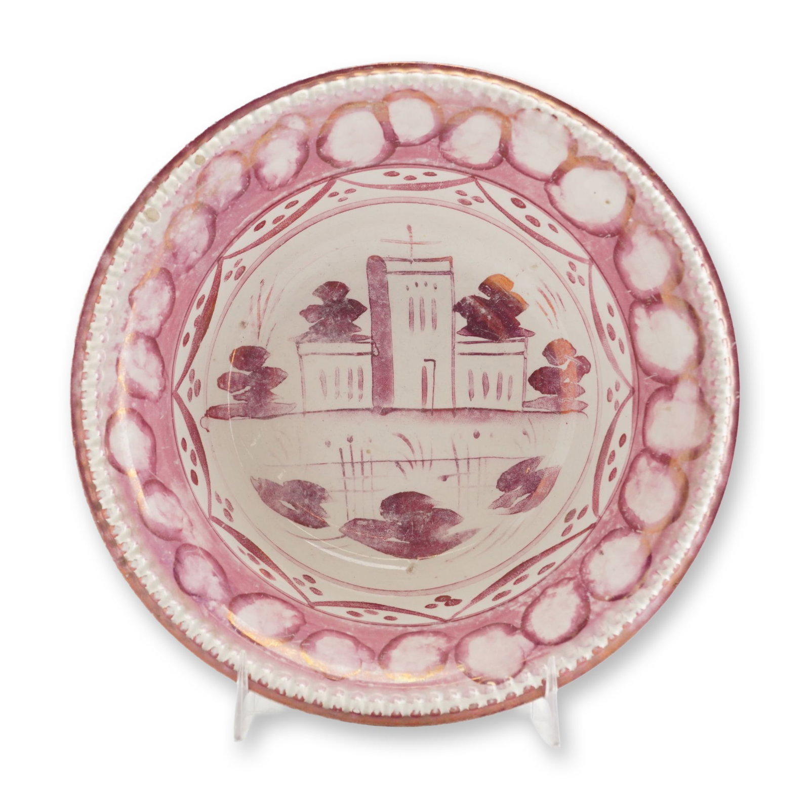 Wedgwood English Pink Lustreware Bowl: This English Regency-period pink lusterware bowl, made circa 1810, features hand-painted architectural and landscape decoration. The circular earthenware vessel has a molded beaded rim and a low foote