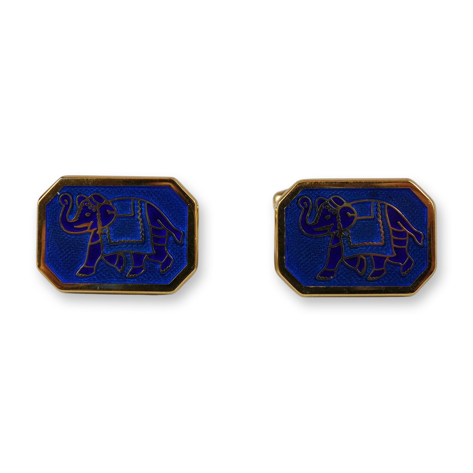 A Pair of Wedgwood Gold-Toned and Blue Enamel Elephant Motif Cufflinks: A pair of octagonal cufflinks by Wedgwood featuring an elephant motif. Each cufflink is constructed from gold-toned metal with a face featuring clipped corners. The design depicts a profile view of a