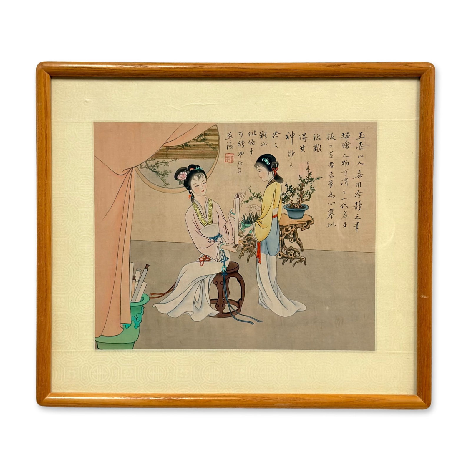 Chinese Print Depicting Two Women in Traditional Clothing: This artwork is a framed Chinese print depicting two women in traditional clothing engaged in refined activities within a scholar's studio. One woman is seated on a dark wood barrel stool holding a ve