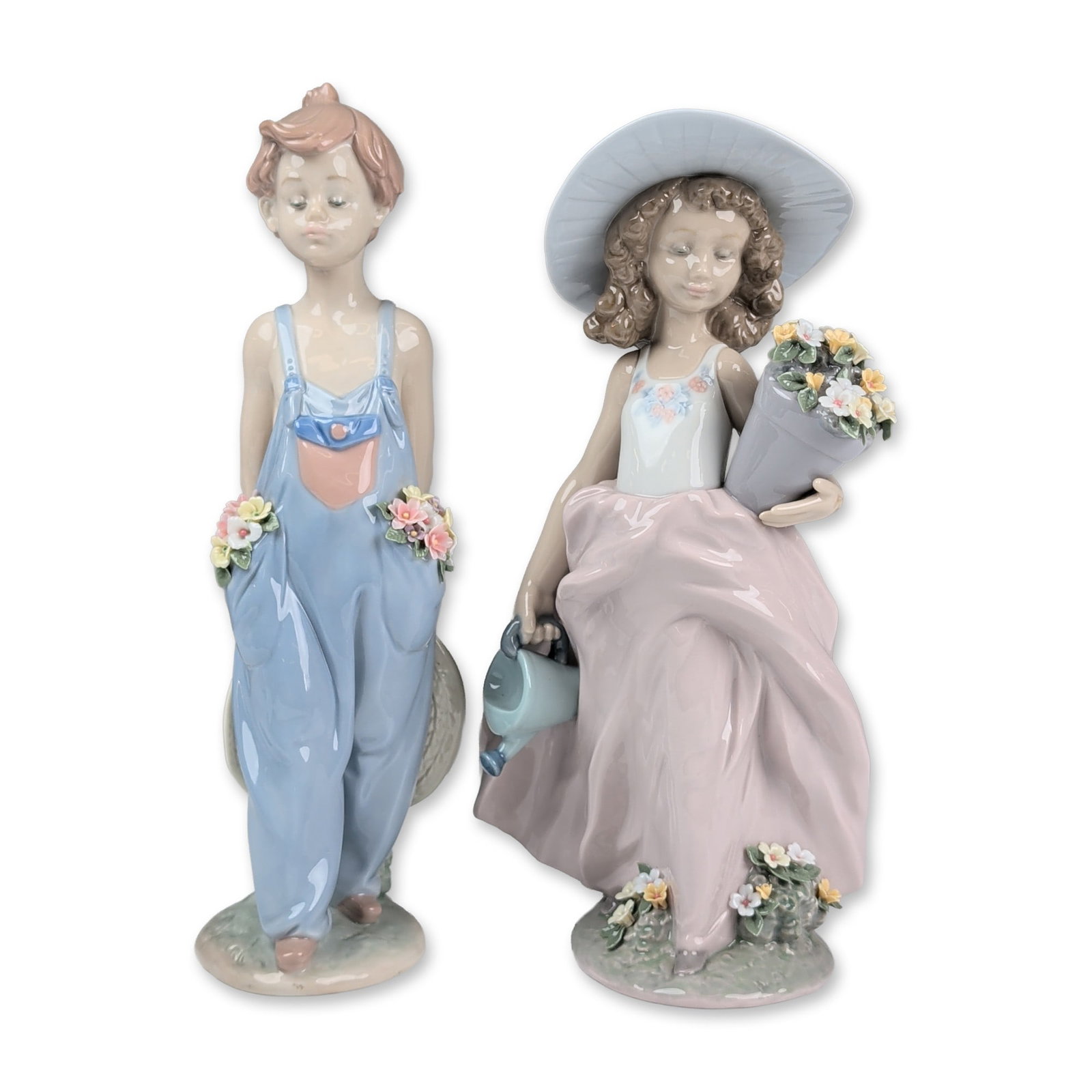2pc Lladro Porcelain Figurines, Pocket Full of Wishes 01007650 & A Wish Come True 01007676: Two glazed porcelain figurines include A Wish Come True depicting a girl holding a pot of flowers and Pocket Full of Wishes depicting boy in coveralls with pockets filled with flowers. Each piece feat
