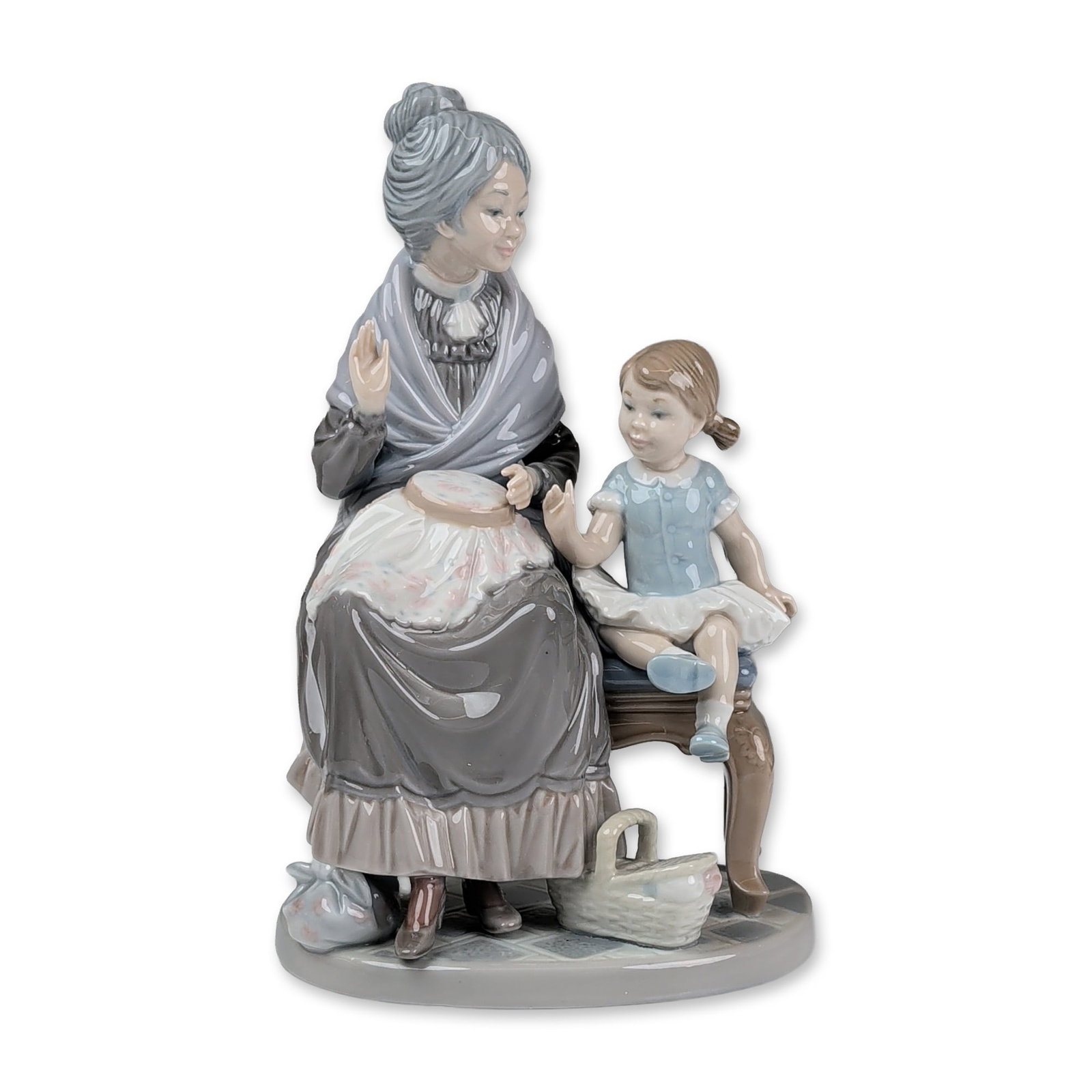 Lladro Glazed Porcelain Figurine, A Visit with Granny 01005305: Lladro Spanish glazed porcelain figurine titled Visit with Granny (Spanish title: Primera Leccion), model number 5305, sculpted by Vincente Martinez. The sentimental scene depicts a grandmother and a 
