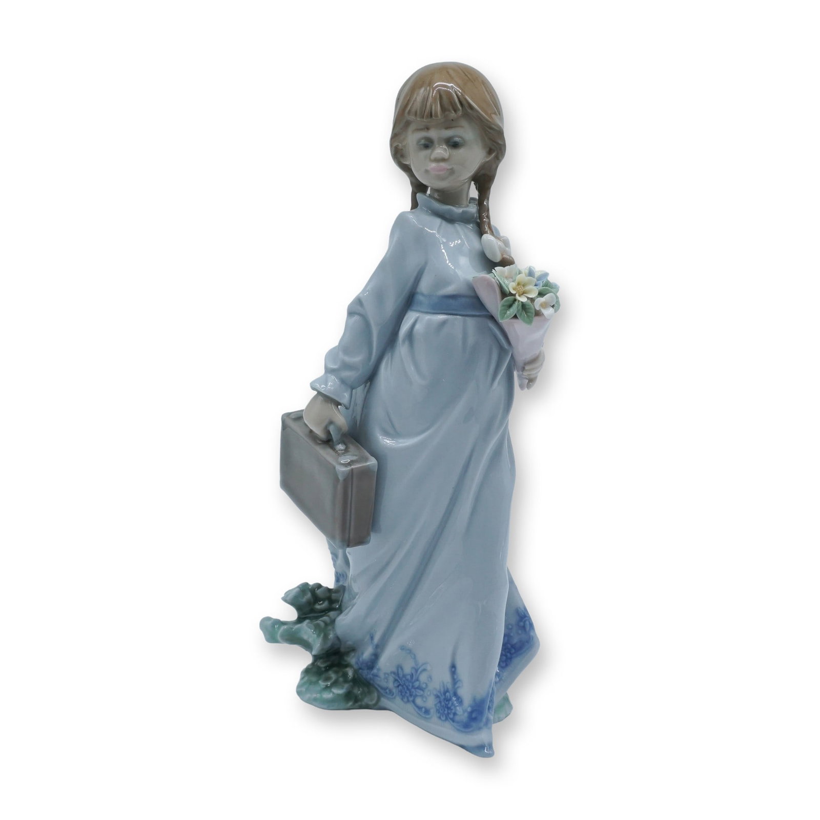 Lladro Porcelain Figurine, School Days 1007604: Charming Lladro porcelain figurine titled School Days (1007604), depicting a young girl with braided hair holding a bouquet and a suitcase, rendered in soft pastel tones with delicate floral detail, t