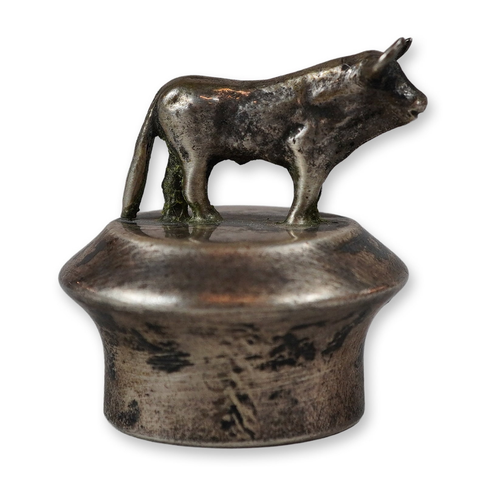 Sterling Silver Bull Figural Wine Bottle Stopper: A sterling silver wine bottle stopper featuring a cast figurine of a standing bull or ox. The animal is modeled in a naturalistic standing pose with prominent horns and tail, mounted onto a flared, ci