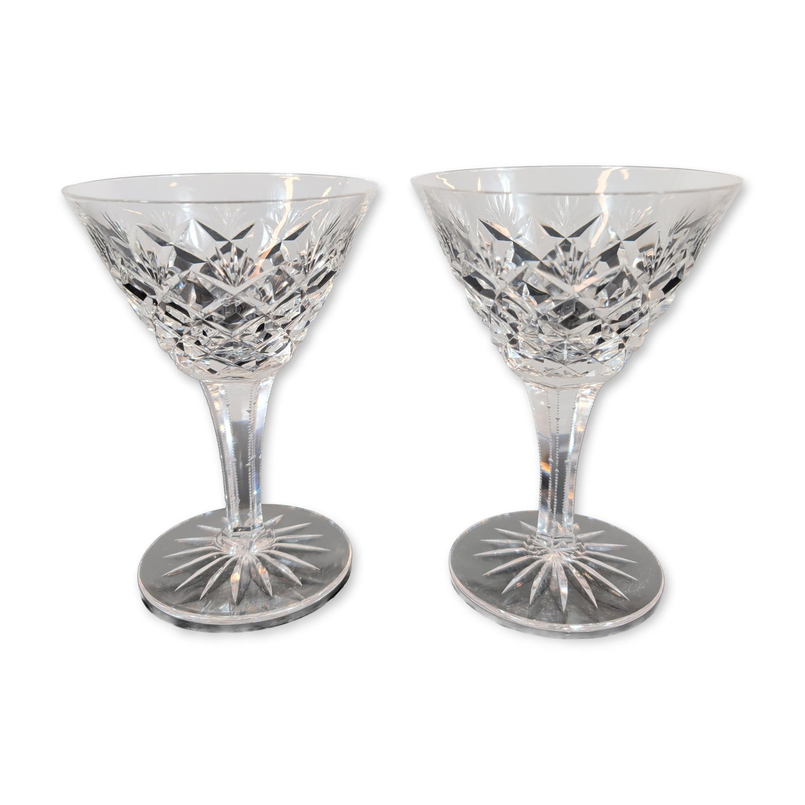 Pair of Cut Crystal Stemware Glasses: Pair of cut crystal stemware glasses, featuring a conical flared bowl decorated with a lower band of cross-hatched diamond cuts beneath a band of fan cuts. The hexagonal faceted stem is adorned with v