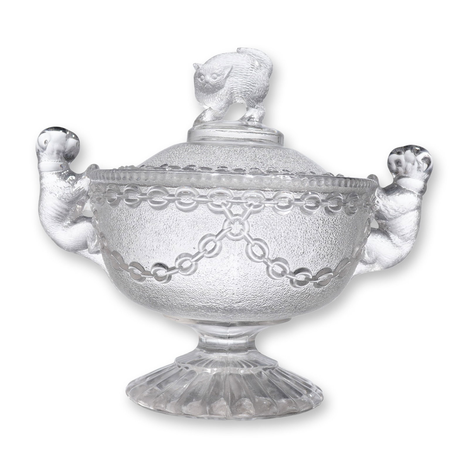 Sowerby Pressed Glass Covered Candy Dish with Cat Finial and Dog Handles: A pressed glass covered sugar or candy dish, featuring a clear glass body and lid. The vessel rests on a short, ribbed pedestal base with molded ribbing detail. The bowl and domed lid exhibit extensiv