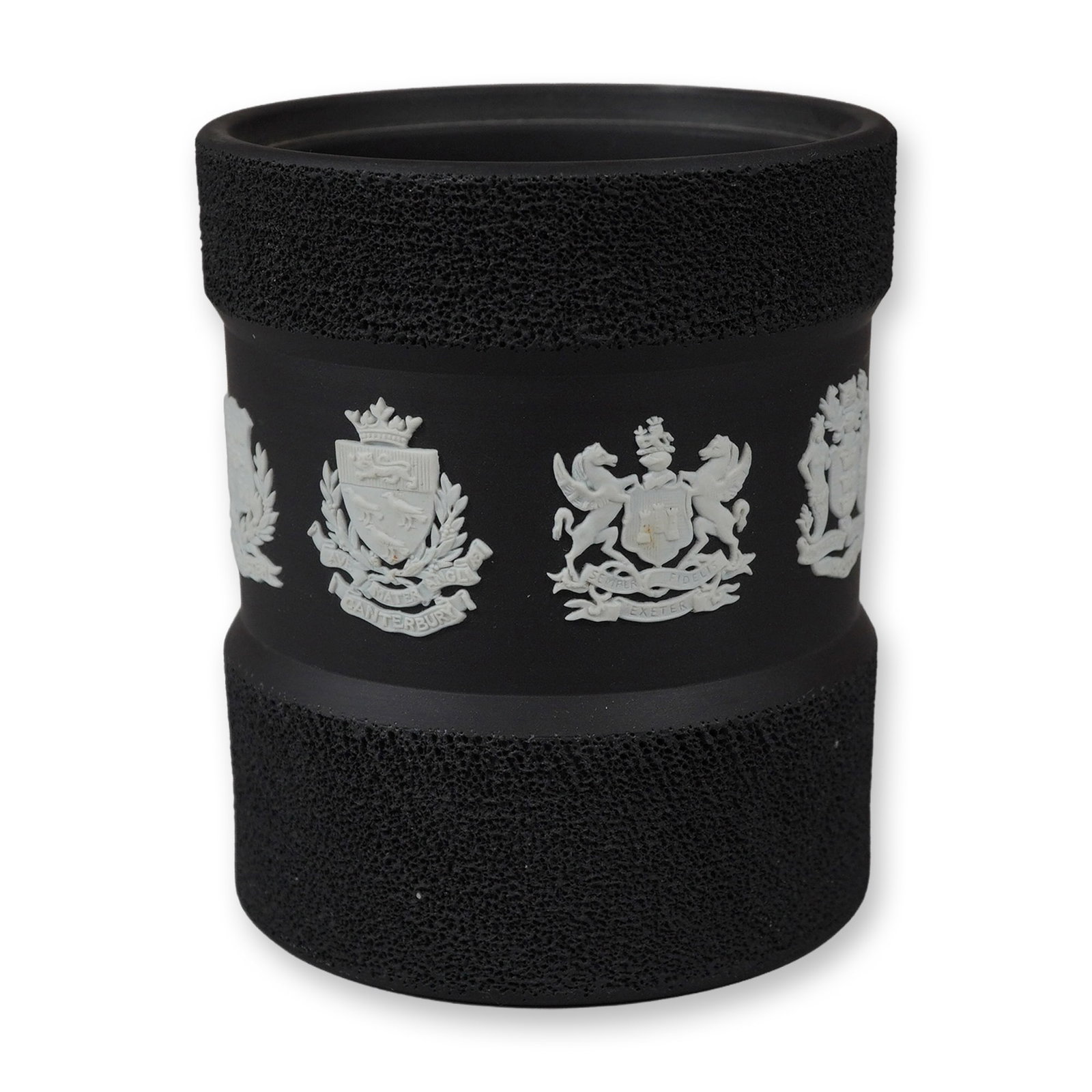 Wedgwood Black Basalt and White Jasperware Tobacco Jar Base: A Wedgwood black basalt cylindrical vessel, identified as the base of a tobacco jar. The piece is crafted from fine-grained black stoneware with a matte finish. The body features a central indentation