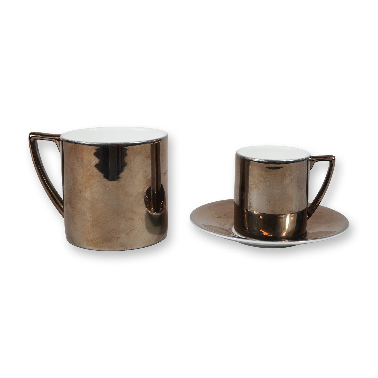 A Trio of Jasper Conran for Wedgwood Bronze Lustreware Bone China Tableware: This lot features a trio of bone china pieces designed by Jasper Conran for Wedgwood, characterized by a modernist, minimalist aesthetic. The collection includes one large cylindrical mug and one smal