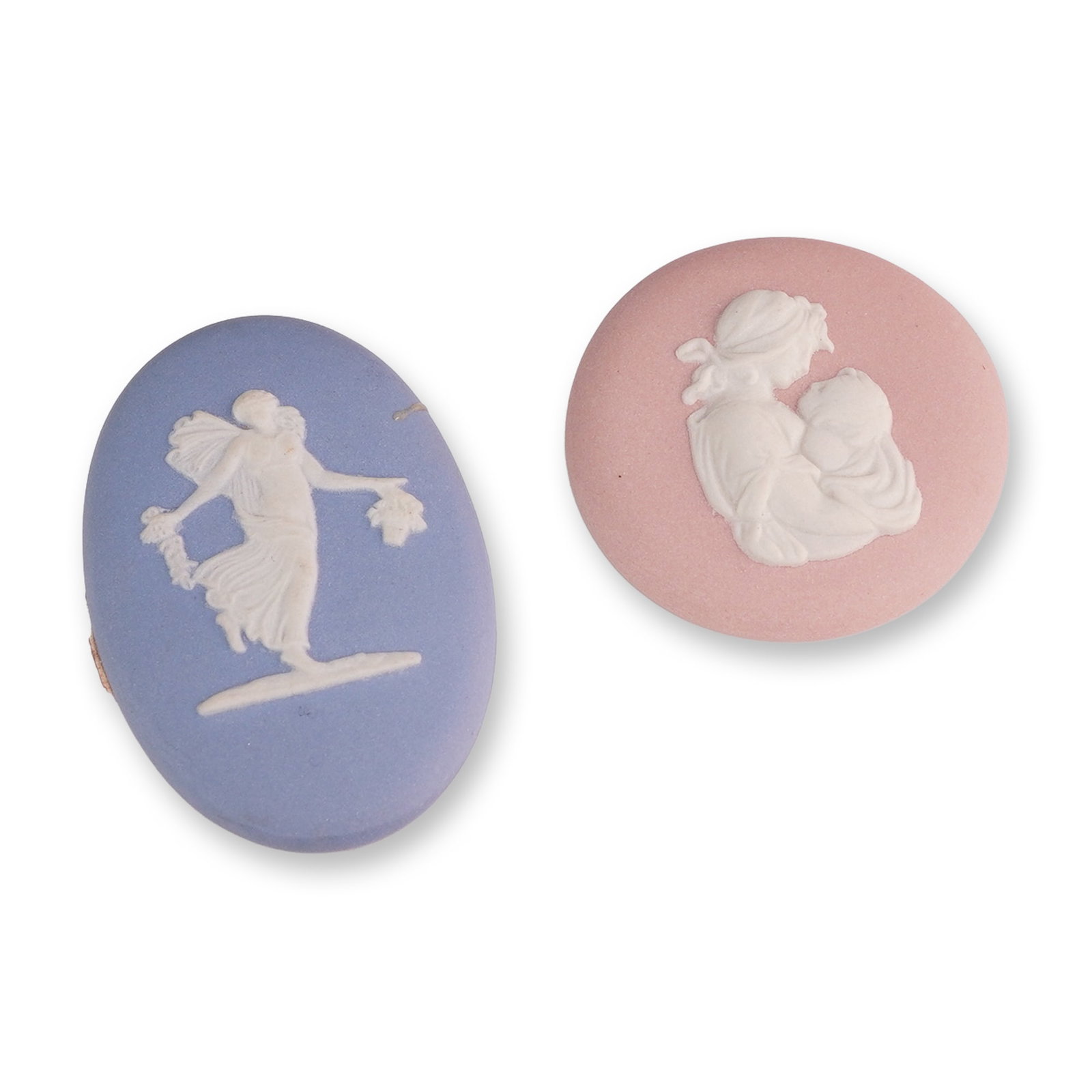 Two Jasperware Cameo Plaques: Two jasperware cameo plaques, including one pink circular example and one pale blue oval example. The pink circular cameo features a white sprigged bas-relief depicting a mother cradling an infant, wi