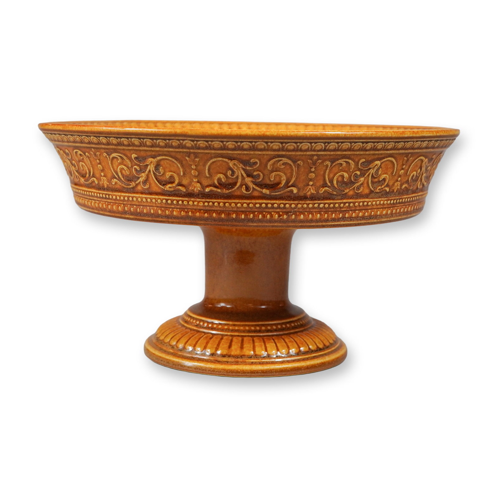 Wedgwood Ochre Glazed Earthenware Pedestal Compote Bowl: This pedestal compote bowl, also known as a tazza, is an earthenware piece produced by Wedgwood, finished in a monochromatic ochre-colored transparent lead glaze. The form features a wide, shallow bow