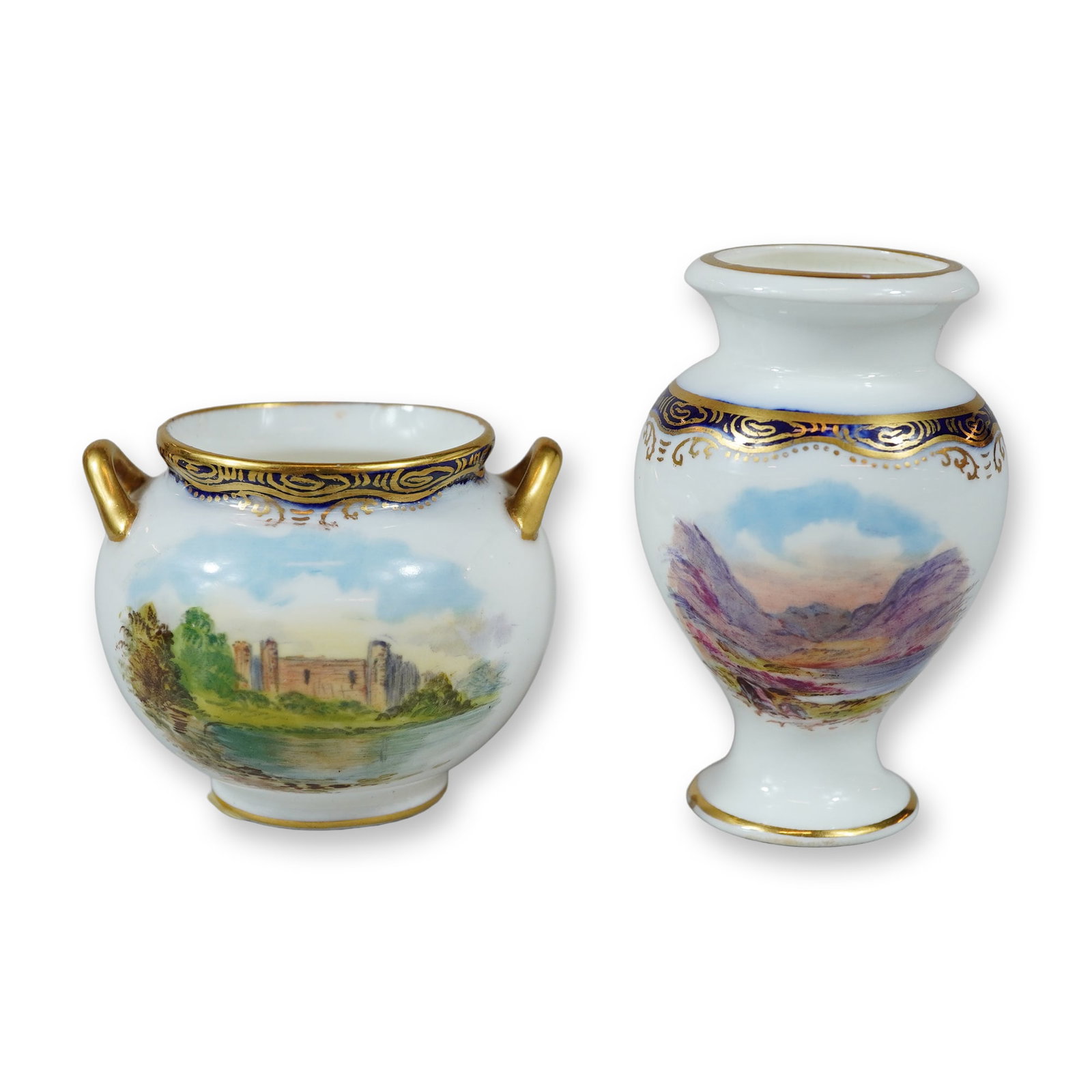A Pair of Wedgwood Hand Painted Miniature Porcelain Cabinet Vases: This pair of miniature porcelain cabinet pieces consists of a cauldron-shaped handled pot and a footed baluster vase manufactured by Wedgwood in England. The pieces are constructed from fine bone chin