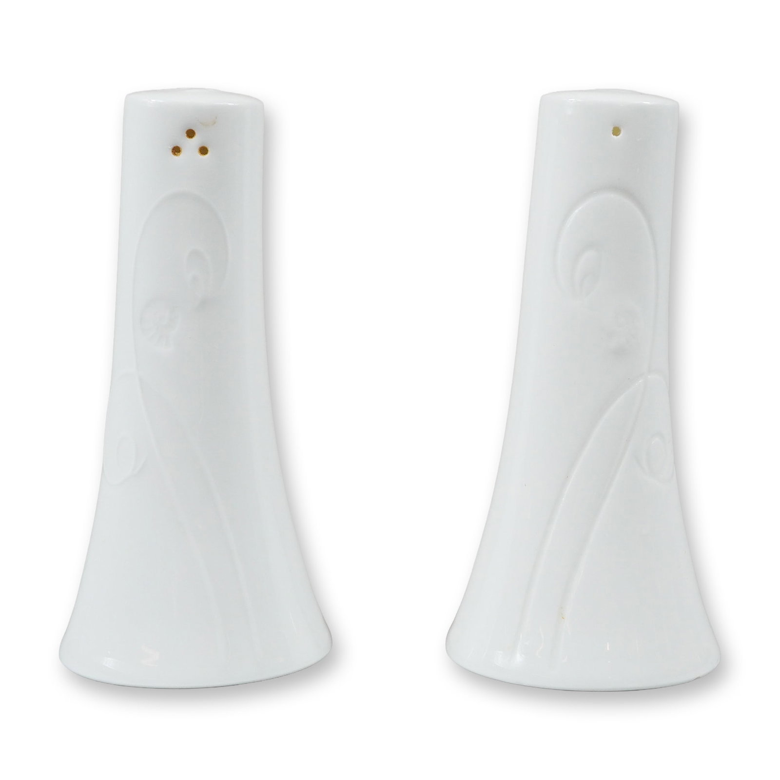 A Pair of Wedgwood White Ceramic Salt and Pepper Shakers: A pair of white salt and pepper shakers produced by Wedgwood. The shakers feature a flared, tapered silhouette with an oval base. The surface decoration consists of foliate and geometric motifs. One s