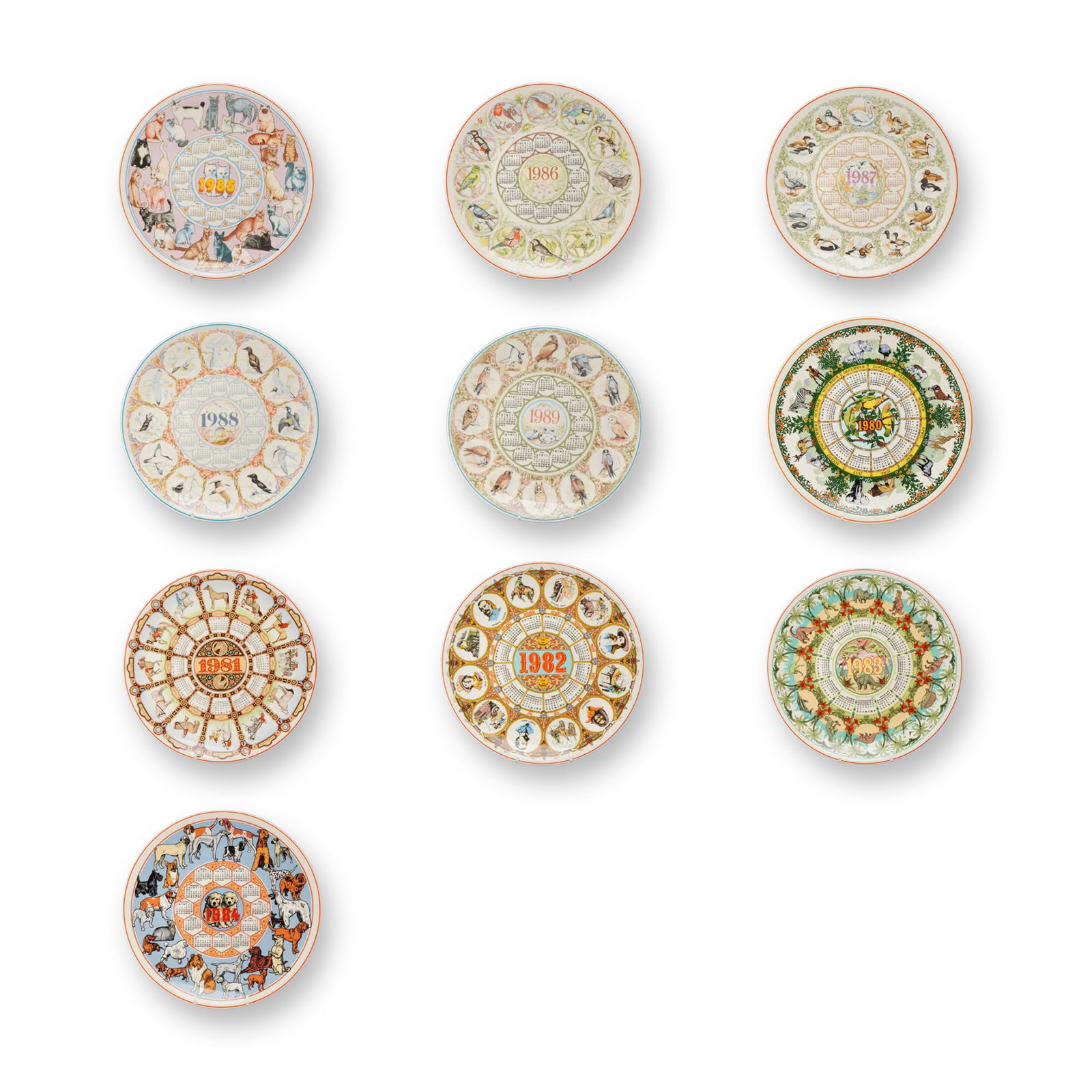 10pc Wedgwood Ceramic Calendar Plates 1980-1989: A collection of ten ceramic calendar plates manufactured by Wedgwood, covering each year of the decade from 1980 to 1989. Each plate is designed with a central year and a circular 12-month calendar