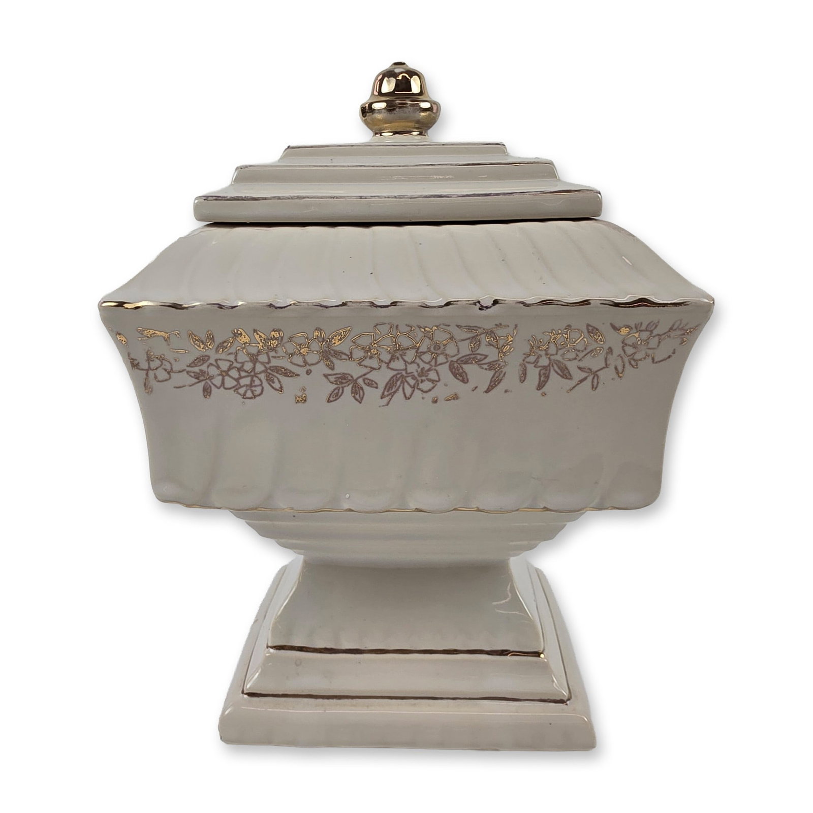 McCoy USA Wedding Cake Covered Jar: McCoy Pottery, USA. Mid-20th century footed square covered jar in the Wedding Cake pattern, produced in glazed earthenware with a cream finish. The form features a vertical fluted and scalloped body