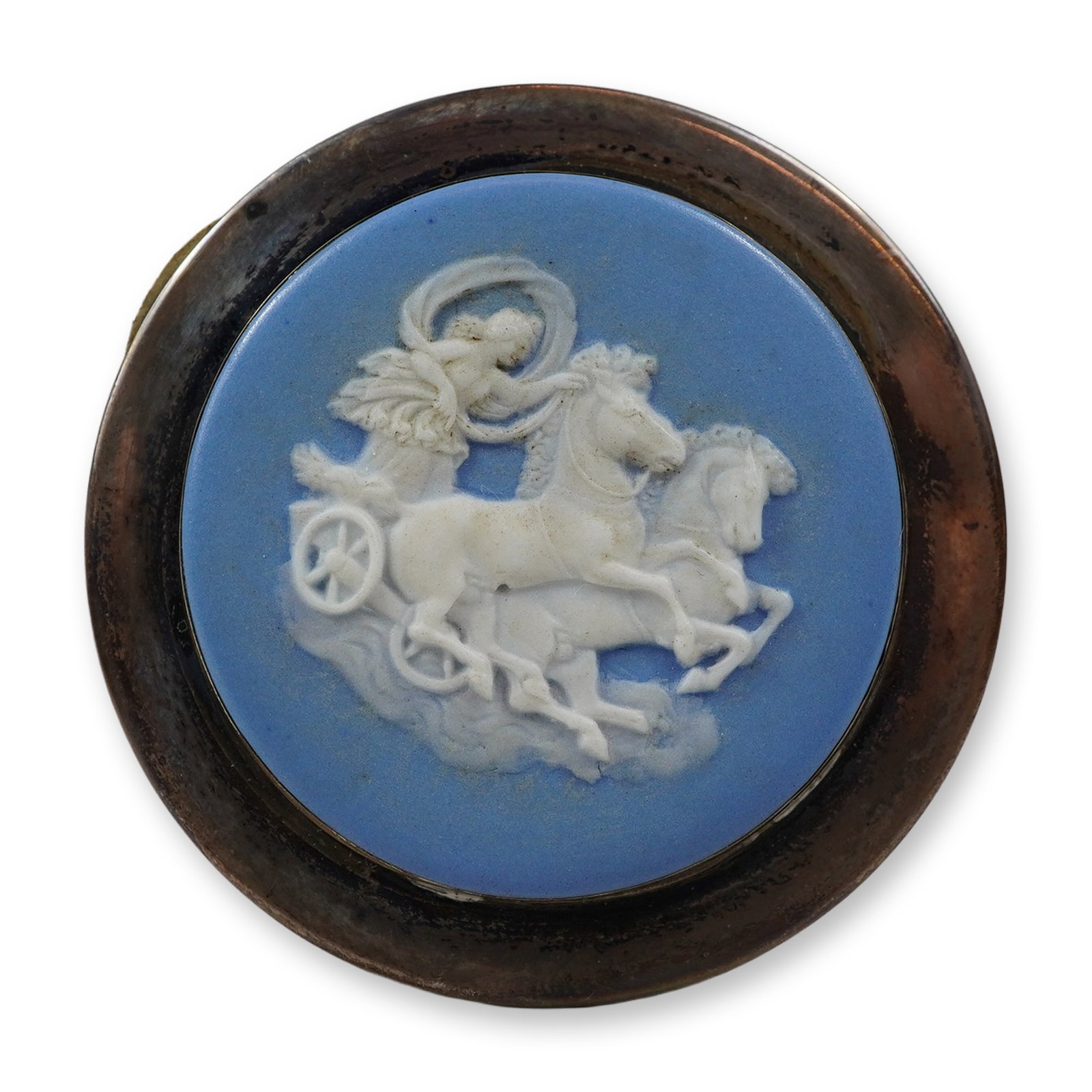 Wedgwood Sterling Silver and Jasperware Medallion: A circular medallion featuring a light blue jasperware ceramic insert produced by Wedgwood, set within a sterling silver frame. The jasperware centerpiece is decorated with a white bas-relief