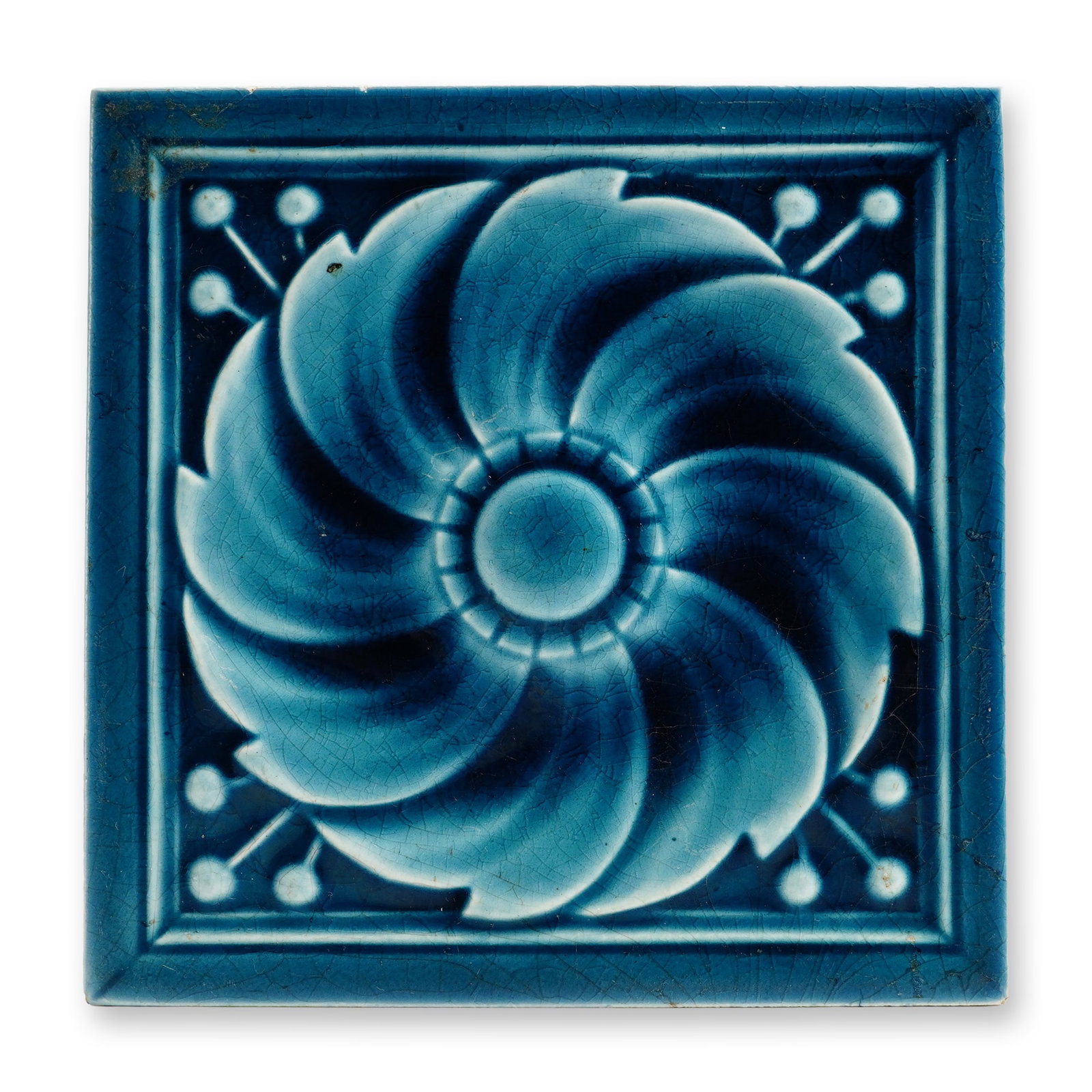 Victorian Figural Floral Ceramic Tile: Victorian period relief-molded earthenware decorative tile. The square form features a stylized swirling floral medallion accented by budding stems in each corner, finished in a translucent