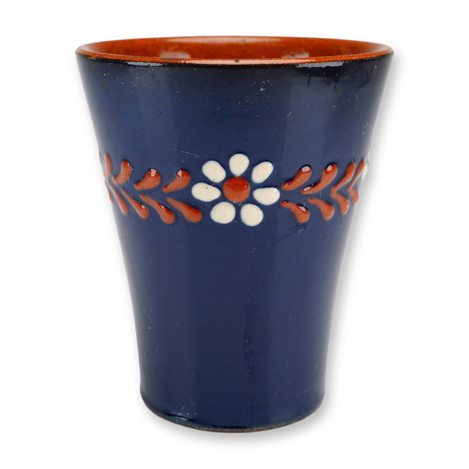 Vintage Redware Blue Art Pottery Bud Vase: This blue art pottery vase with low relief work of flowers and red leaves is finished in a deep cobalt blue glaze on the exterior, while the interior and rim display a contrasting reddish-brown terrac