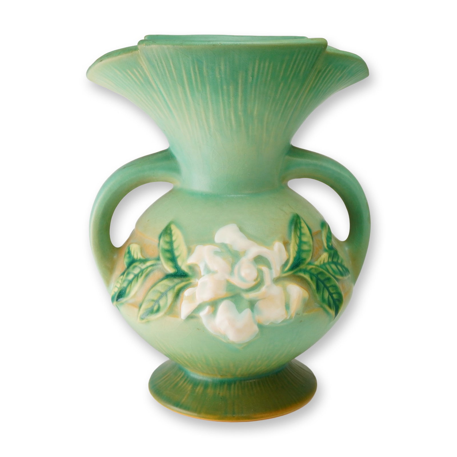 Roseville Pottery Green Double Handled Vase, Gardenia: This vintage 1950 Roseville Pottery ceramic vase is executed in the Gardenia pattern, model number 684-8. The double handled urn form features a bulbous body and a widely flared, scalloped rim. The pi