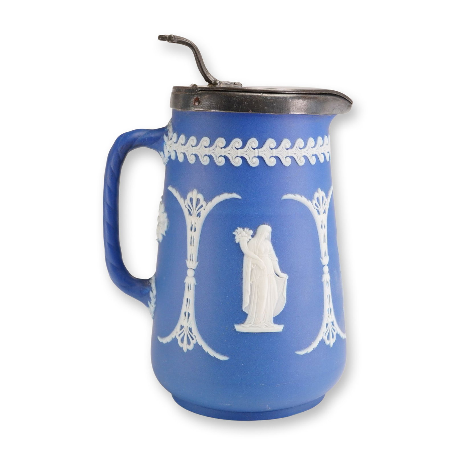 Wedgwood Jasperware Dip Portland Blue Pitcher with Metal Lid: This 19th-century Wedgwood Jasperware pitcher is crafted in a deep Portland blue dip with white sprigged bas-relief neoclassical decorations. The tapered stoneware body features a series of classical 
