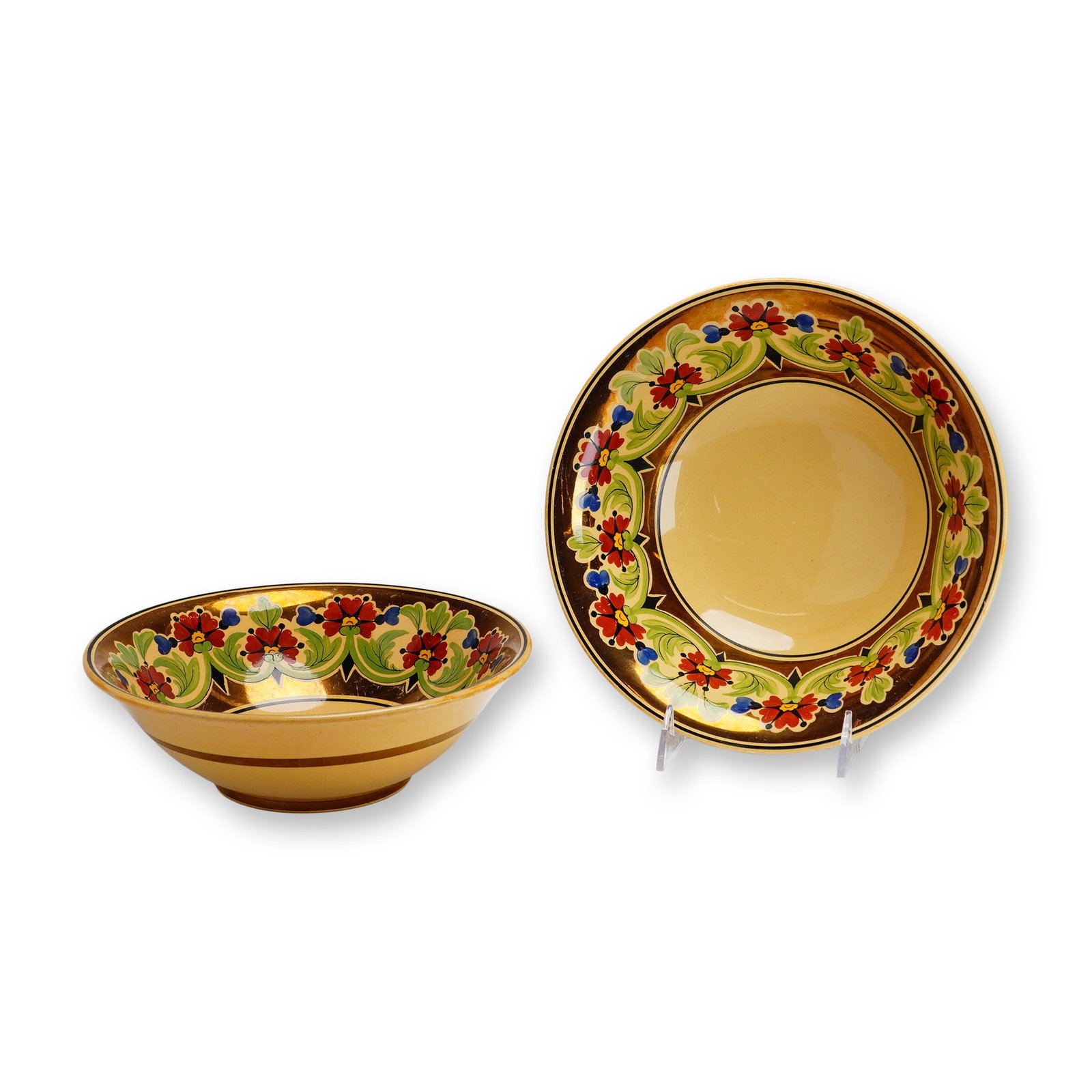 Two Wedgwood Millicent Taplin Caneware Serving Bowls, c. 1930: The bowls are made from a buff-colored earthenware body with a clear glaze. The interior rim is decorated with a hand-painted frieze of stylized red flowers with yellow centers, blue bell-shaped