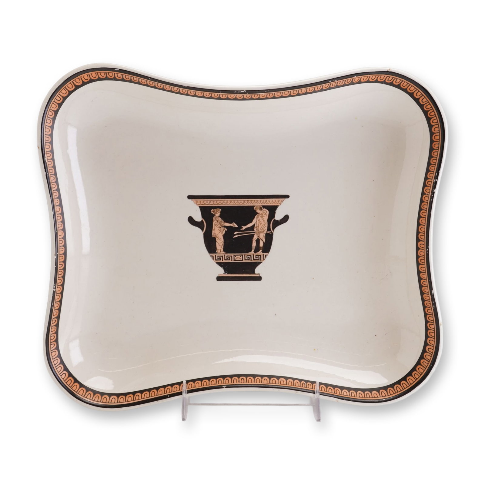Wedgwood Creamware Etruscan Style Lobed Tray: This Wedgwood creamware tray is decorated in the neoclassical Etruscan style. Crafted from fine earthenware, the vessel features a shallow rectangular form with a scalloped and lobed rim. The central