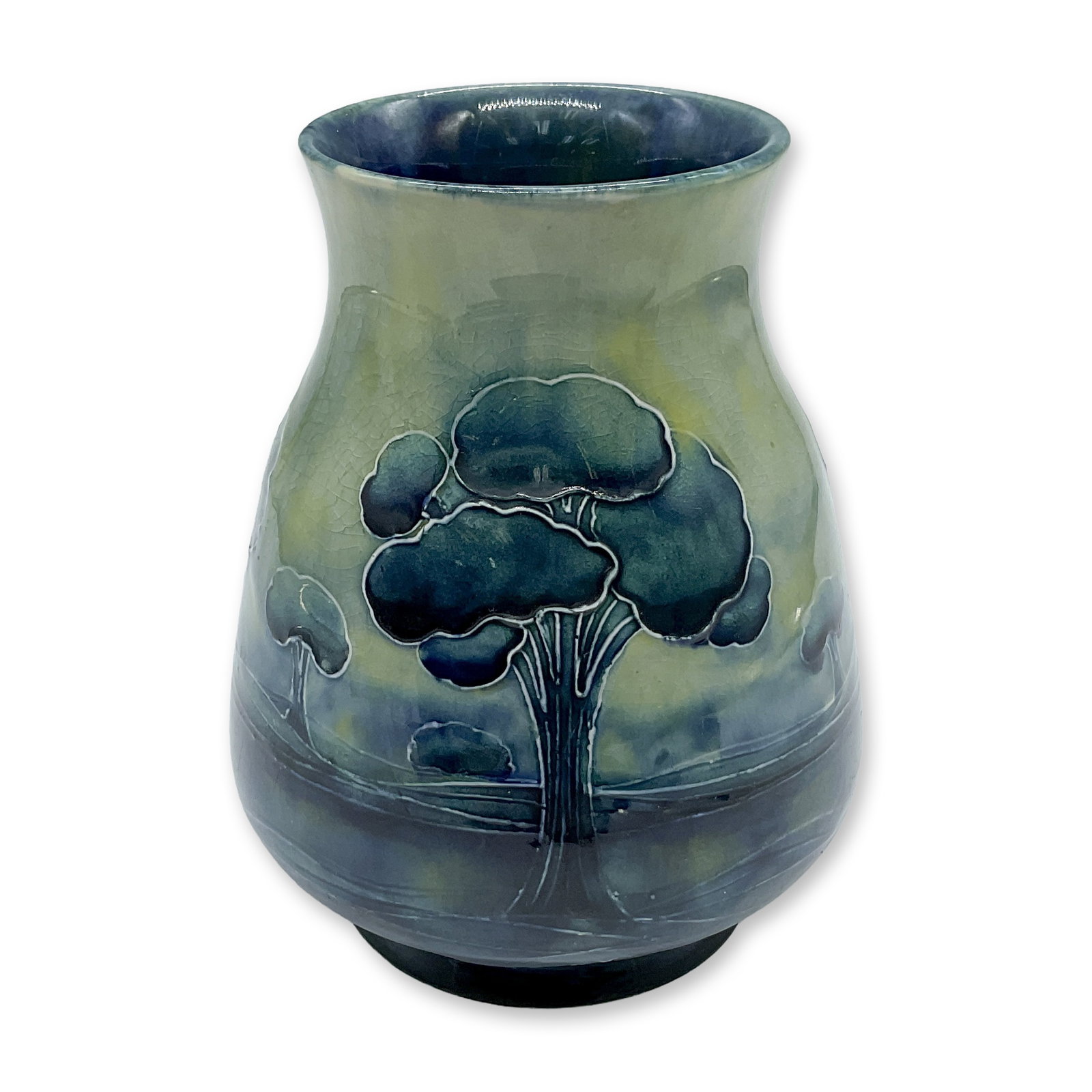 Moorcroft for Liberty & Co. Vase, Hazeldene: A small table vase. Features a landscape in yellow, green and blue glaze. Liberty & Co. stamped. Artist signed. Artist: William Moorcroft Dimensions: 4"W x 5"H Date or Era: 20th century Manufacturer
