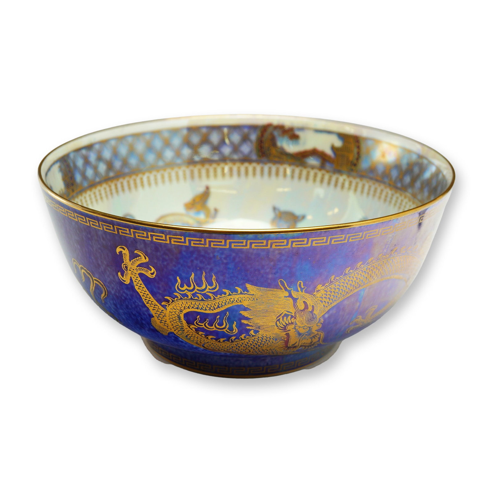 Wedgwood Fairyland Lustre Bowl, Celestial Dragon Z4829: Designed by Daisy Makeig-Jones. The bowl has a mottled mixed-blue exterior luster glaze decorated with a gilt transfer-printed Celestial Dragon and stylized flames. The rim and foot are finished with 
