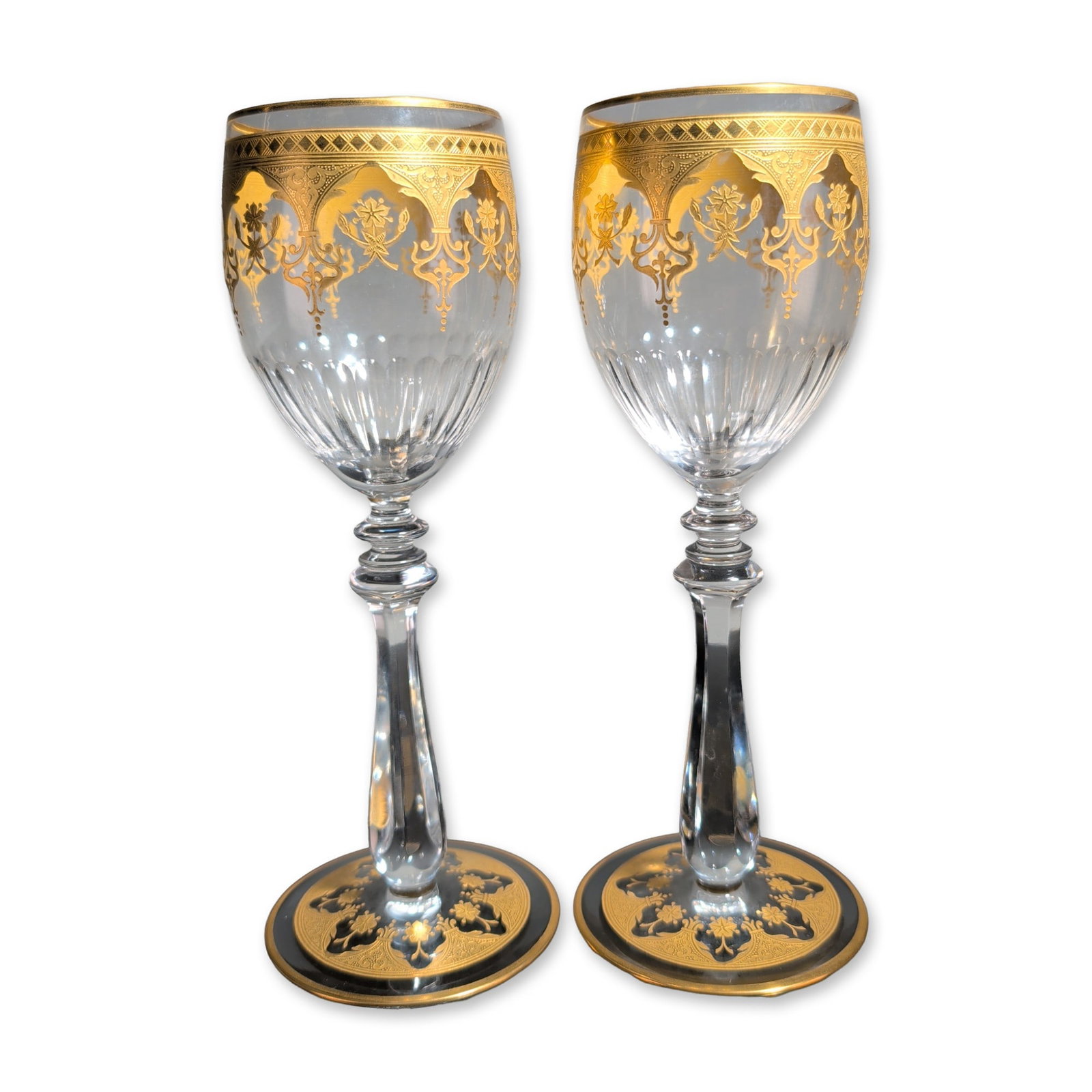 2pc Baccarat France Prestige Gold Encrusted Crystal Wine Glasses: Baccarat, France, pair of wine goblets in lead crystal, Prestige pattern. The tulip-shaped bowls feature wide gold-encrusted bands at the rims with foliate and scrolled palmette decoration above verti