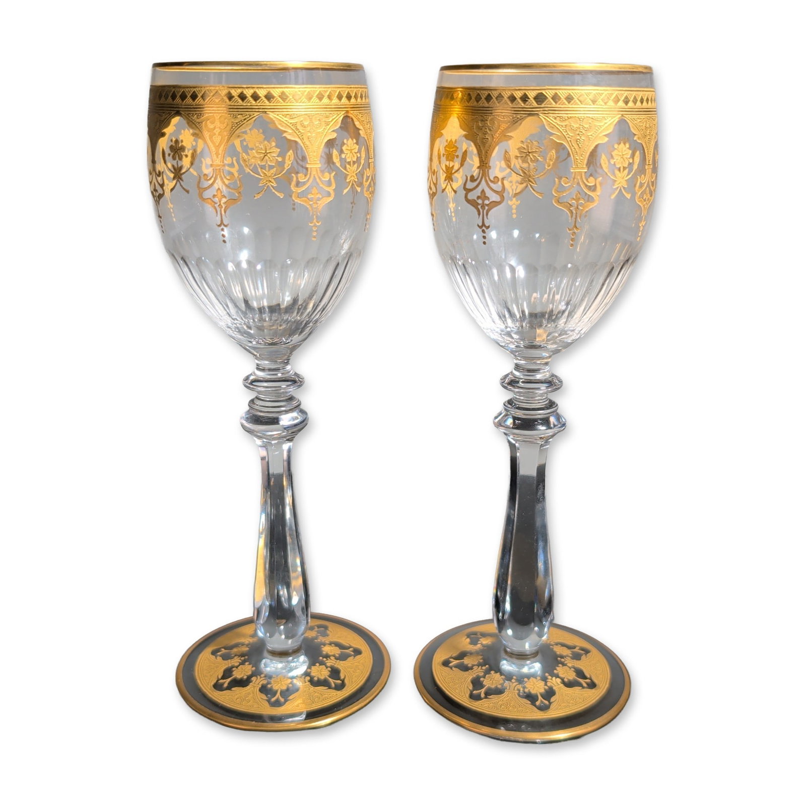 2pc Baccarat France Prestige Gold Encrusted Crystal Wine Glasses: Baccarat, France, pair of crystal wine goblets in Prestige pattern. The tulip-shaped bowls feature wide gold-encrusted bands at the rims with foliate and scrolled palmette decoration above vertical fl