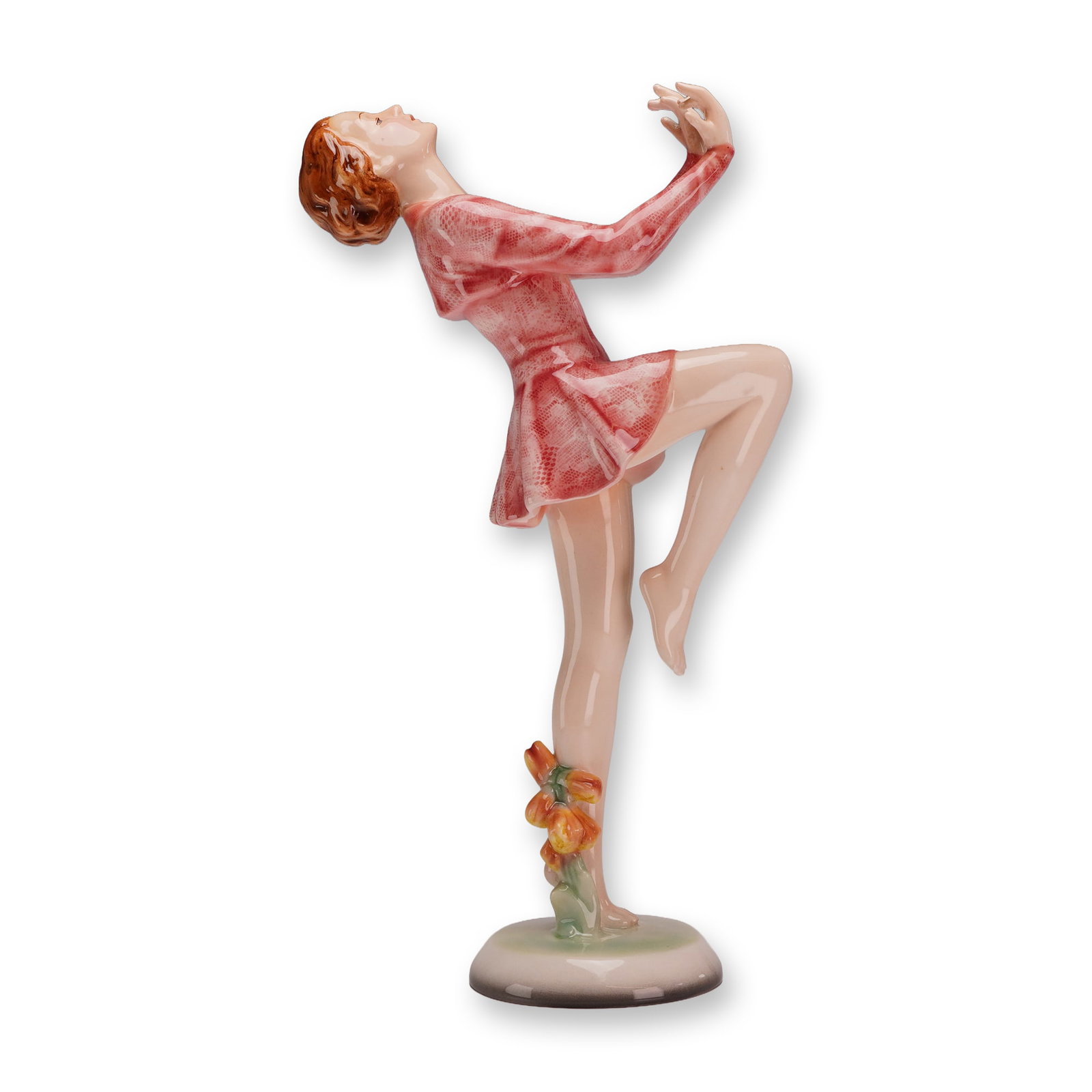 Goldscheider Art Deco Dancer Figurine, Model 8711: Depicts an Art Deco style female dancer in a dynamic, expressive pose. The figure is balanced on one leg with the opposite leg bent at the knee, leaning her torso back with arms raised and head tilted