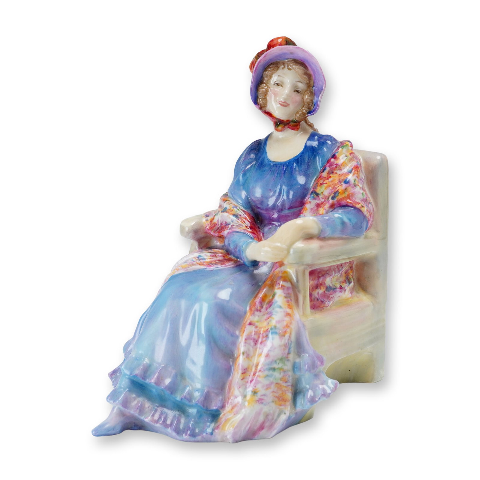 Royal Doulton Porcelain Figurine, Marion HN1583: Part of the Harradine Classics. Designed by Leslie Harradine. Hand painted figure of a seated woman in a blue-purple dress and a patterned shawl. Royal Doulton backstamp. Artist: Leslie Harradine Dime