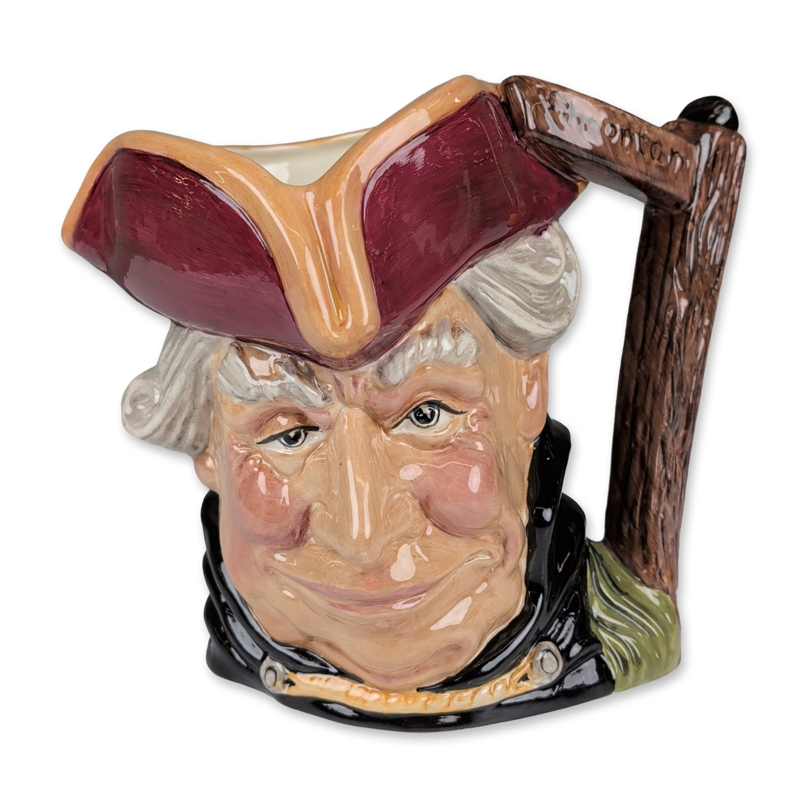 Royal Doulton Prototype Trial Large Character Jug, John Gilpin: The model features a man with a prominent nose, white hair, and beard, wearing a burgundy bicorne hat and a black coat. The handle is formed as a rustic wooden signpost with an inscribed hanging sign 