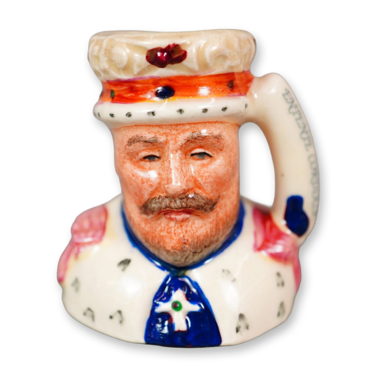 Royal Doulton Colorway Tiny Character Jug, Edward VII D6993: Part of the Kings and Queens of the Realms set. Hand painted tiny figural jug of King of the United Kingdom, the eldest son of Queen Victoria and Prince Albert. White, blue, and red colorations. Handl