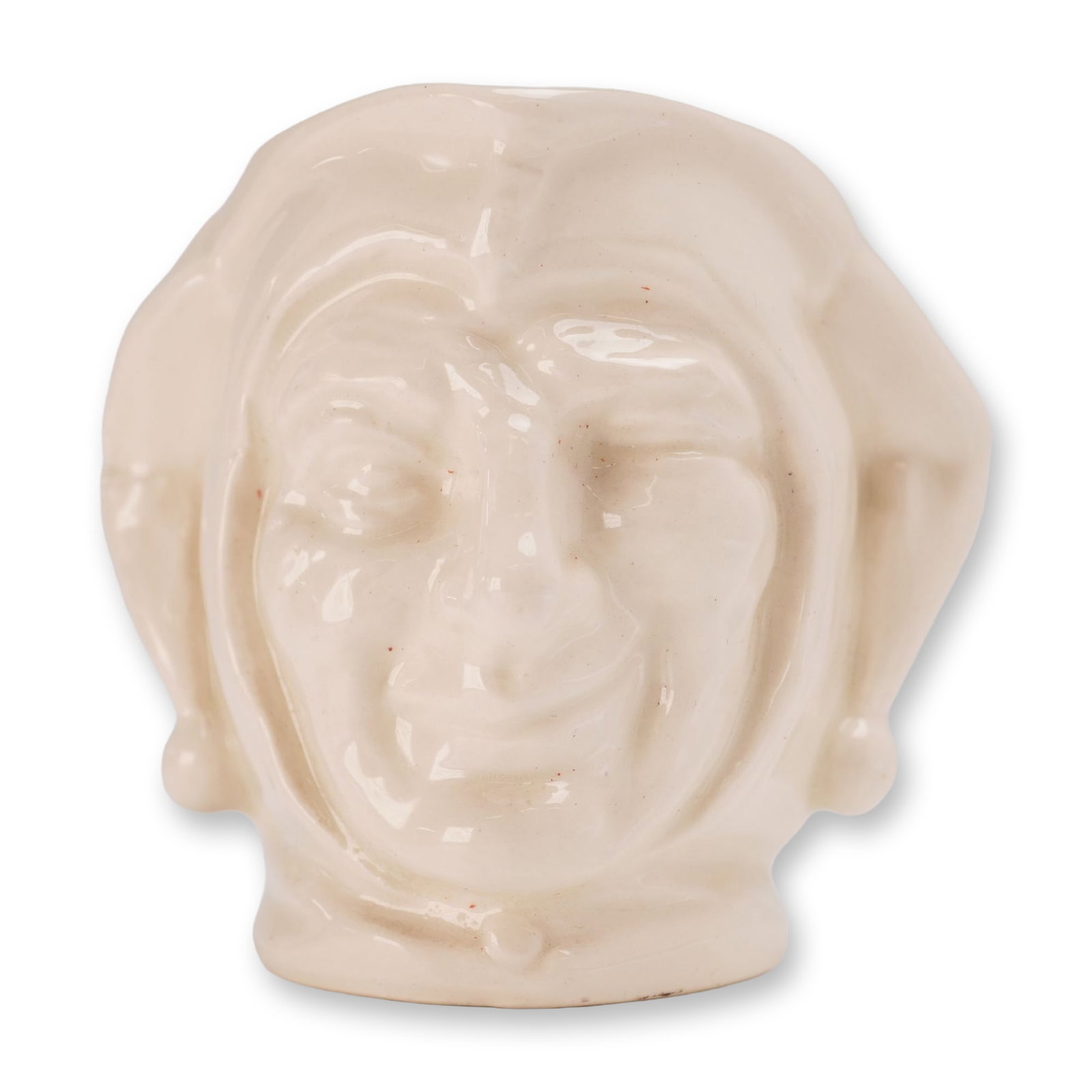 Royal Doulton White Glaze Small Character Jug, Jester: In a monochromatic cream-white glaze. The piece is modeled as The Jester, featuring a winking facial expression and a traditional three-pointed fool's cap with pom-pom terminals. Features a single loo