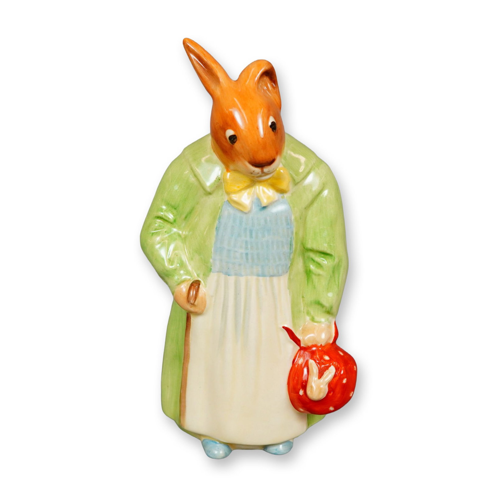 Royal Doulton Bunnykins Figurine, Farmer Bunnykins D6003: Hand-painted Royal Doulton bunny figure, modeled wearing a green coat over a blue and white smock, accented with a yellow bow tie and a red polka-dot handkerchief. Royal Doulton and Bunnykins backstam