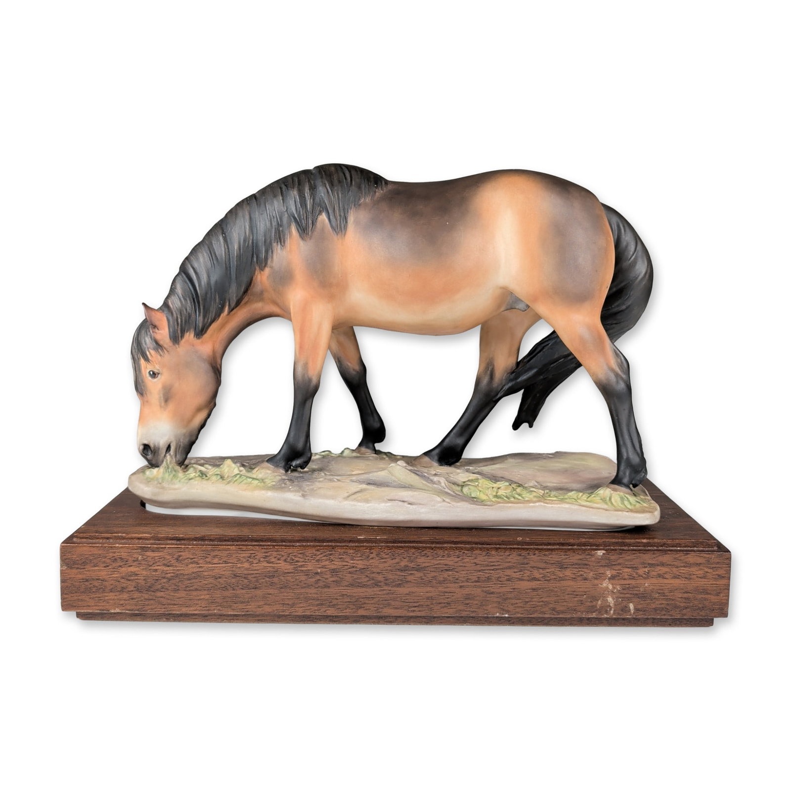 Royal Worcester by Bernard Winskill Bone China Figurine with Base, Exmoor Pony: The hand-painted figure depicts a pony in a grazing pose with a dun coat, dark dorsal stripe, and black points on the mane, tail, and legs. The animal stands on a naturalistic base modeled as rocky te
