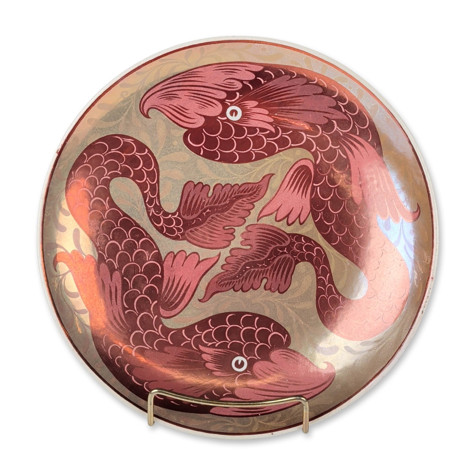 William De Morgan Fulham by Charles Passenger Ruby Luster Double Fish Dish: Featuring a central design of two stylized fish in a circular composition. Rendered in ruby and copper luster glazes with detailed scale patterns and flowing fins against a pale celadon background wit