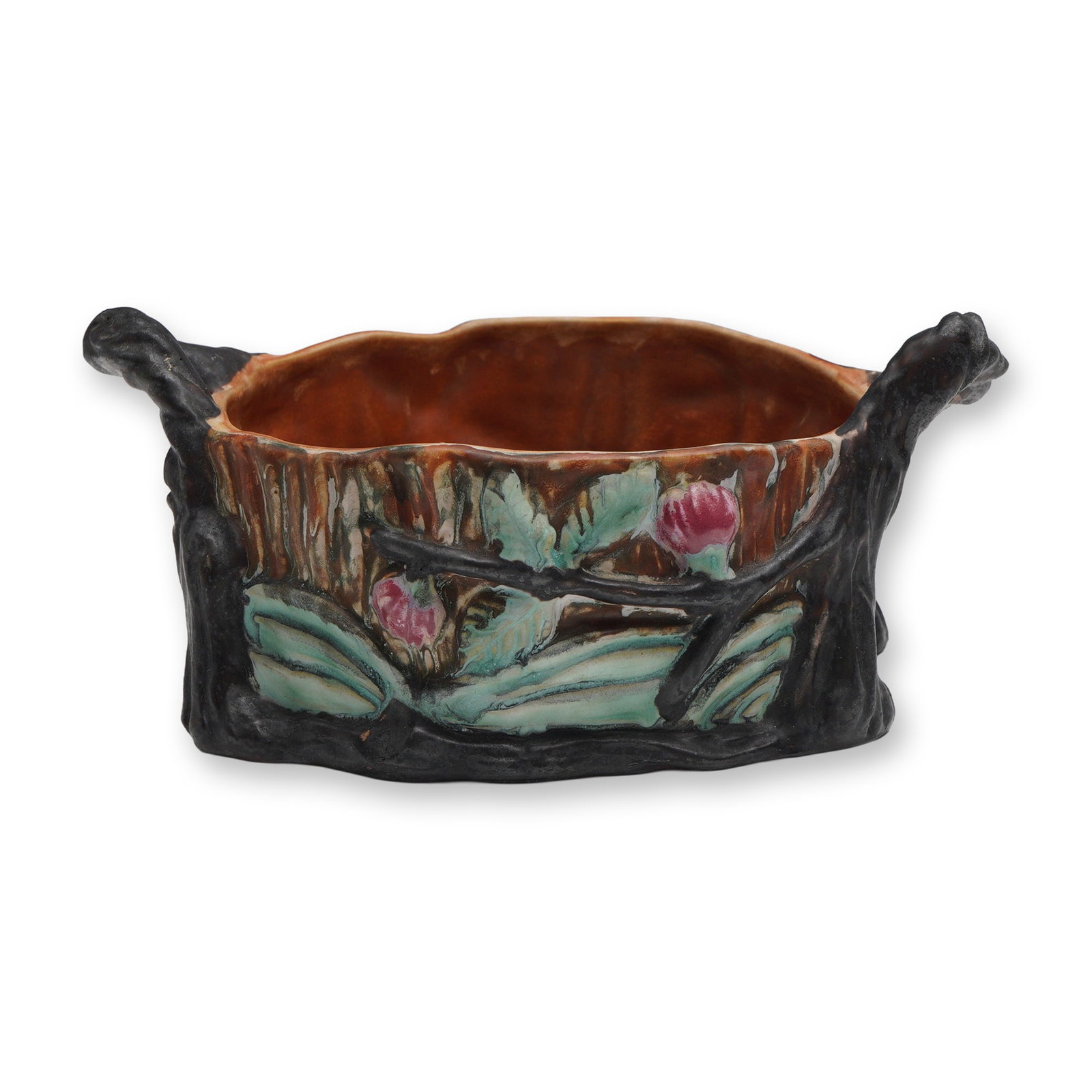Weller Pottery Warwick Tree Trunk Jardiniere with Handles: Weller Pottery Warwick Art jardiniere in the form of a rustic tree trunk with branch-style handles extending from the rim. The body features raised floral and leaf decoration in soft green and rose hu