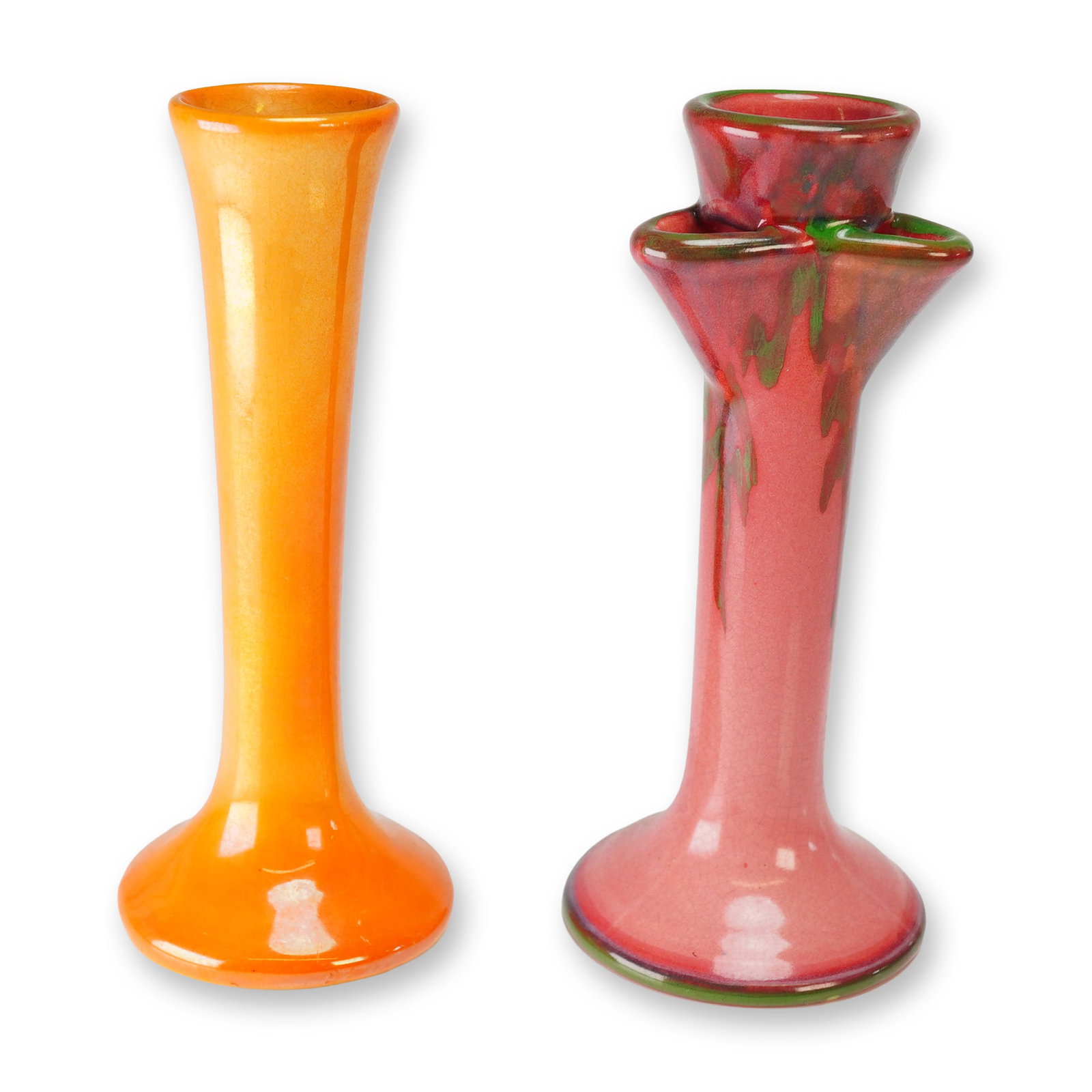 Two Weller Pottery Art Deco Bud Vases: A pair of Weller pottery bud vases including a pink Juneau pattern example with green drip and an iridescent orange example. The first vase is of trumpet form with a flared circular base and rim, fini