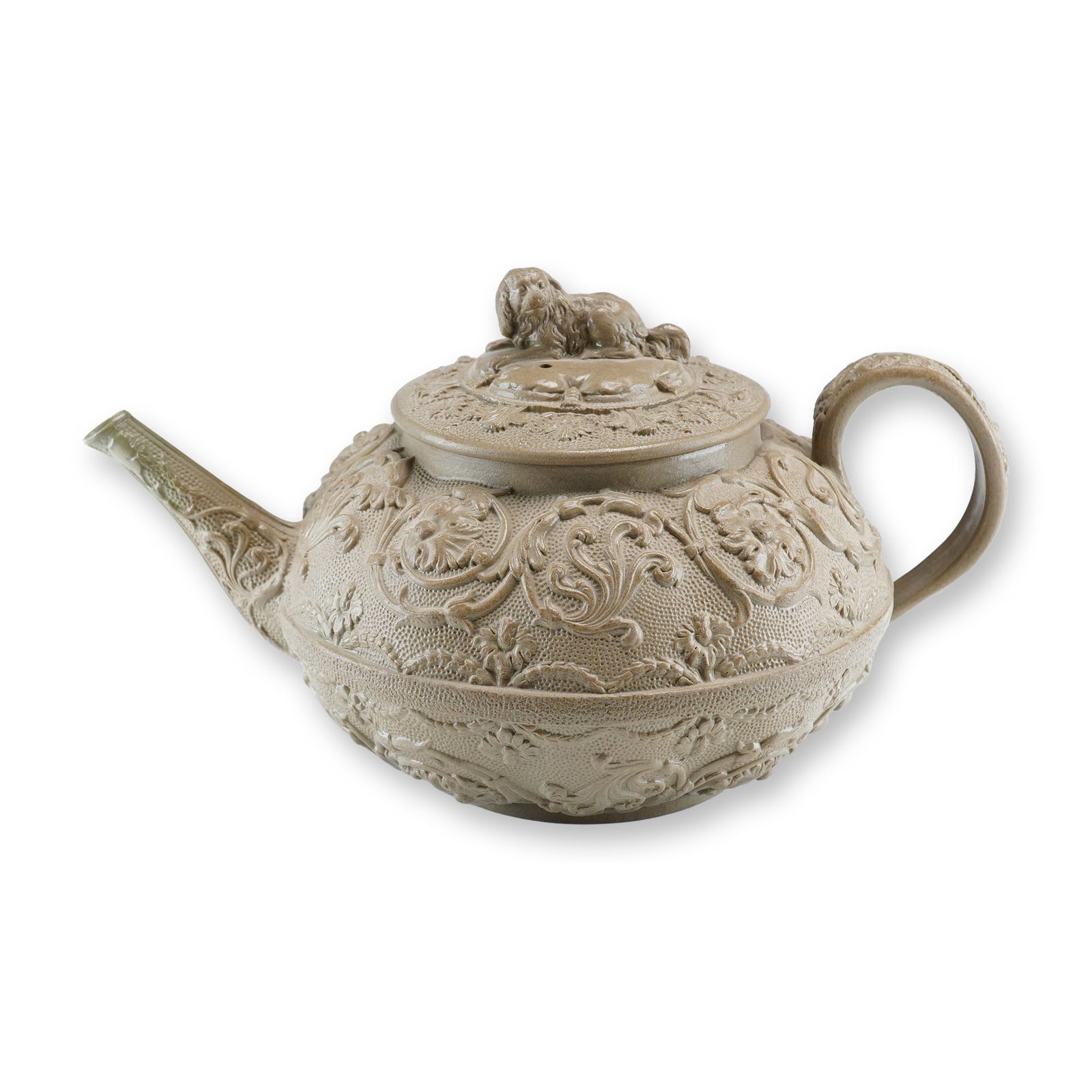 Early 19th Century Wedgwood Caneware Teapot with Spaniel Finial: This early 19th-century Wedgwood teapot is constructed from a tan, dry-bodied stoneware known as caneware. The vessel features a bulbous body with a curved spout and handle, topped with a domed lid. T