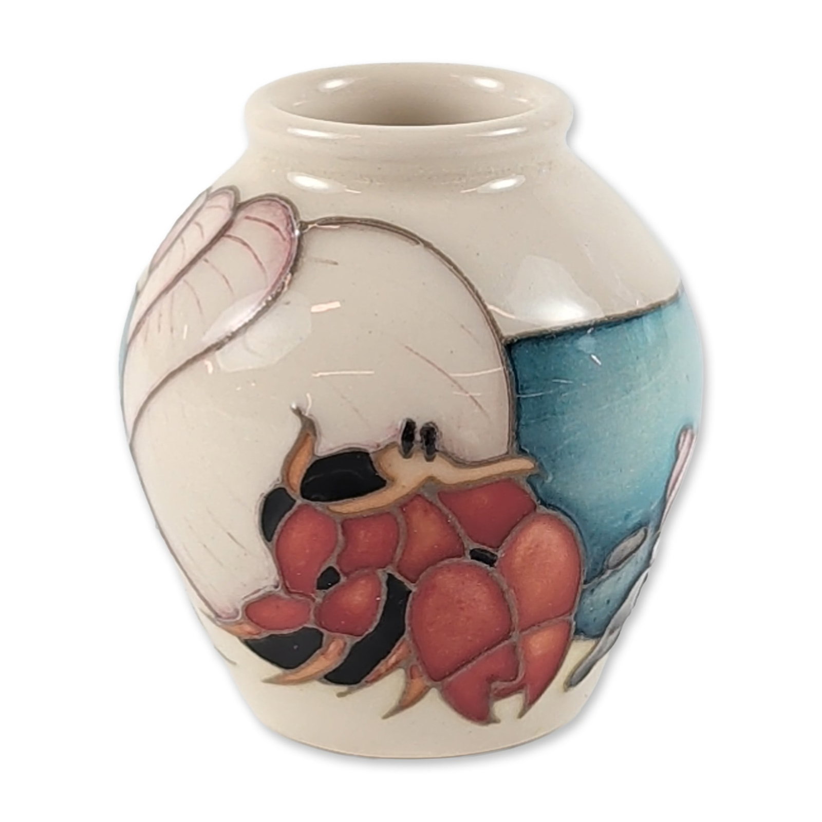 Moorcroft 2005 Hermit Crab Miniature Pottery Vase: Moorcroft pottery miniature ovoid vase in the Hermit Crab pattern, designed by Emma Bossons. The piece features hand-painted tubelined decoration depicting a reddish-pink hermit crab emerging from a