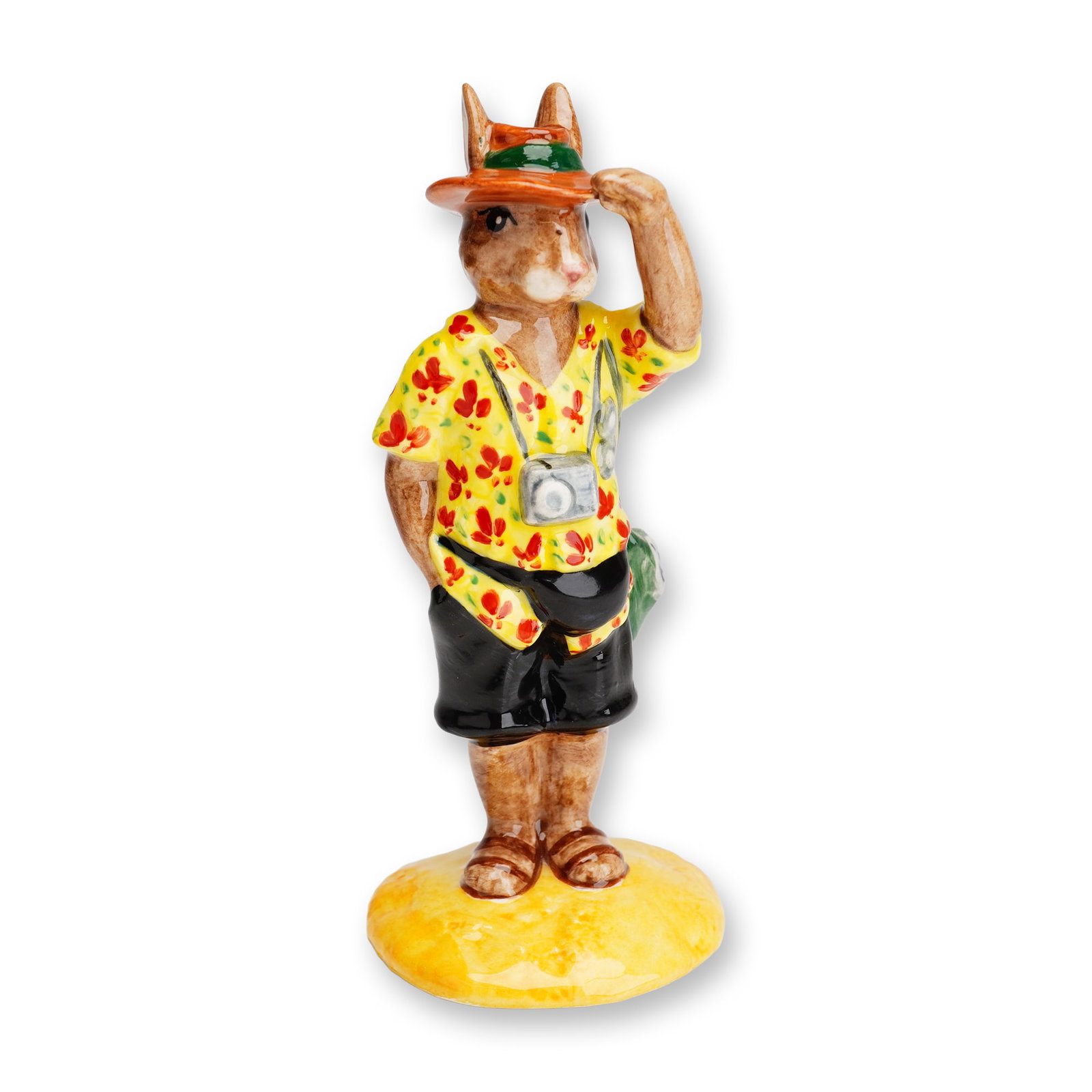 Royal Doulton Bunnykins Artists Copy Figurine, Tourist DB190: A Royal Doulton Bunnykins ceramic figurine titled Tourist, model number DB190. This anthropomorphic rabbit figure is depicted in a traveler ensemble, including an orange wide-brimmed hat with a green 