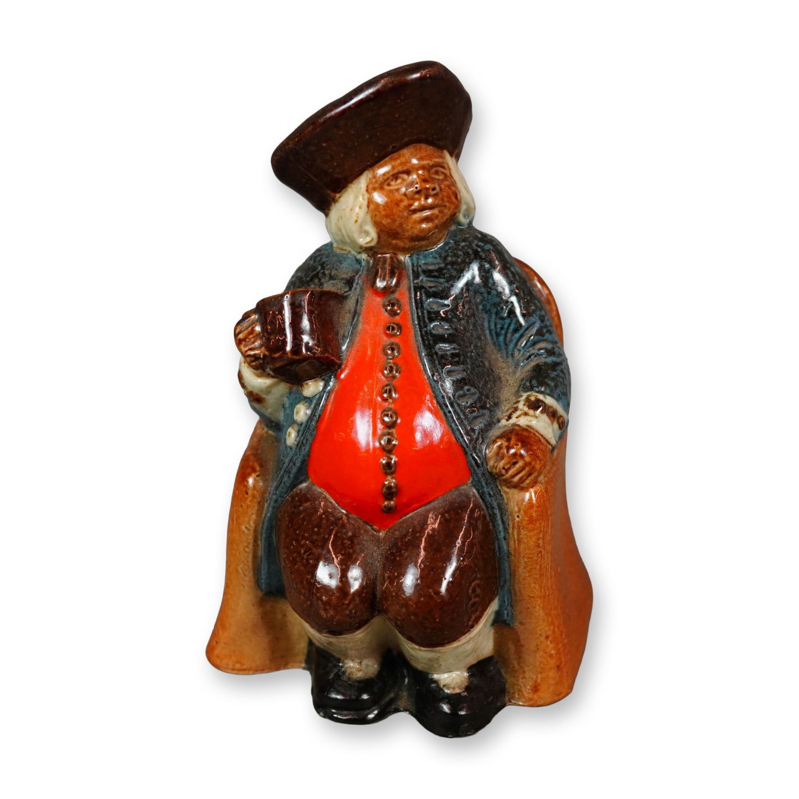 Royal Doulton Lambeth Stoneware Salt-Glazed Advertising Armchair Toby Jug, Ye Olde Cock Tavern: Created for The Old Cock Tavern, this hand-painted salt-glazed figural jug portrays a seated gentleman dressed in a reddish-orange buttoned shirt, blue coat, brown trousers, and a brown hat, holding a