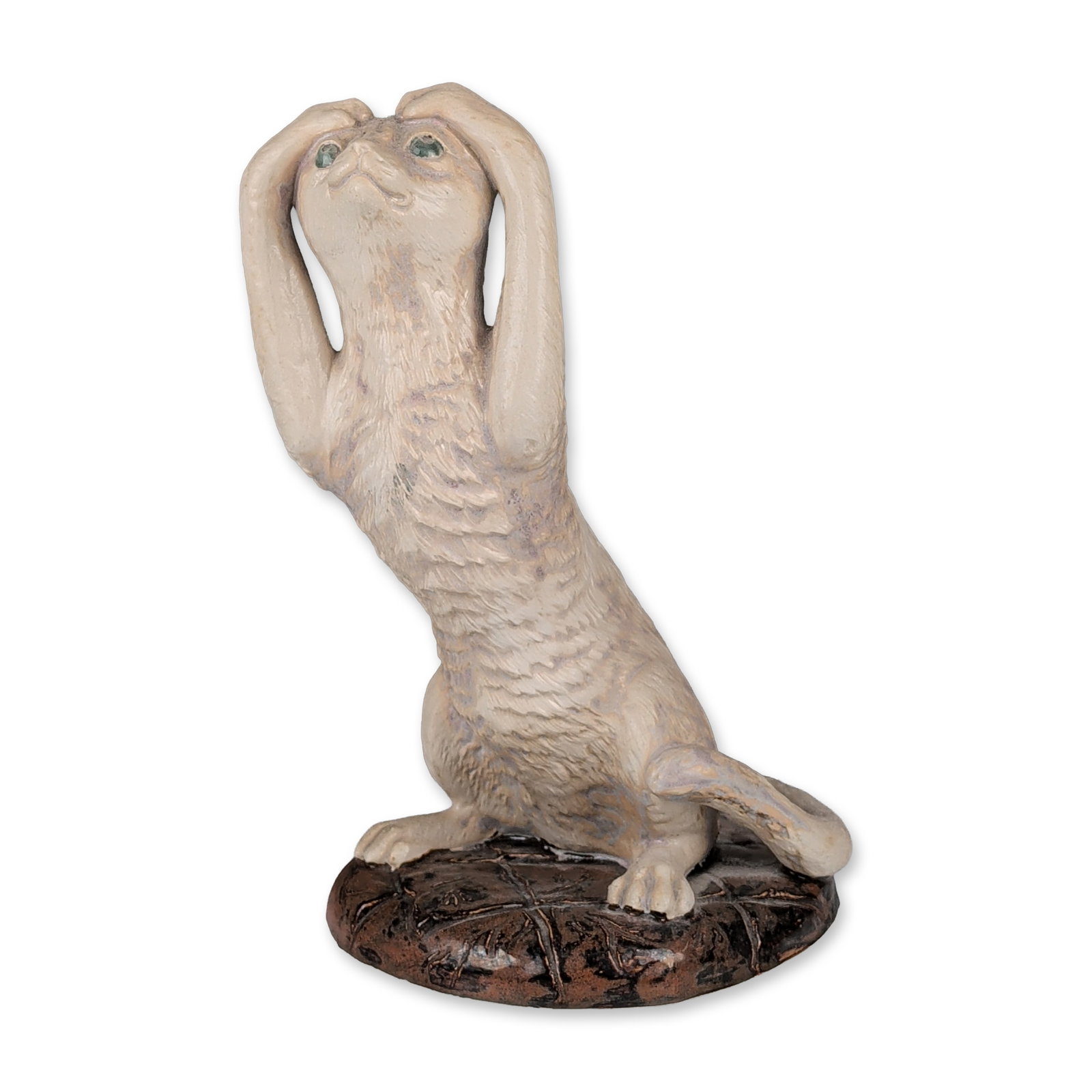 Cobridge Stoneware Stretching Cat Sculpture: Ceramic sculpture of a stylized cat in a stretching pose, paws covering its ears. The figure features a textured cream and buff glaze with subtle purple-grey mottling and green highlights to the eyes.